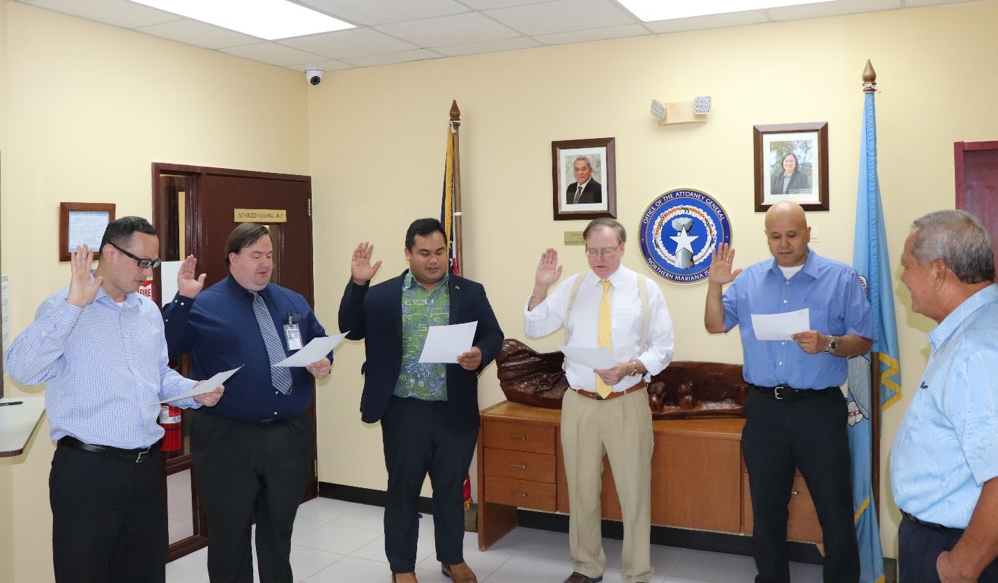 Attorney General Edward Manibusan administers the oath of office to the assistant attorneys general of the civil and criminal division. In the photo from left: AAG Carl Dela Cruz, Civil Division Chief John Lowrey, AAG Jose P. Mafnas Jr., AAG Thomas Schweiger, AAG Charles P. Reyes Jr., and Attorney General Manibusan.AG’s office photo
