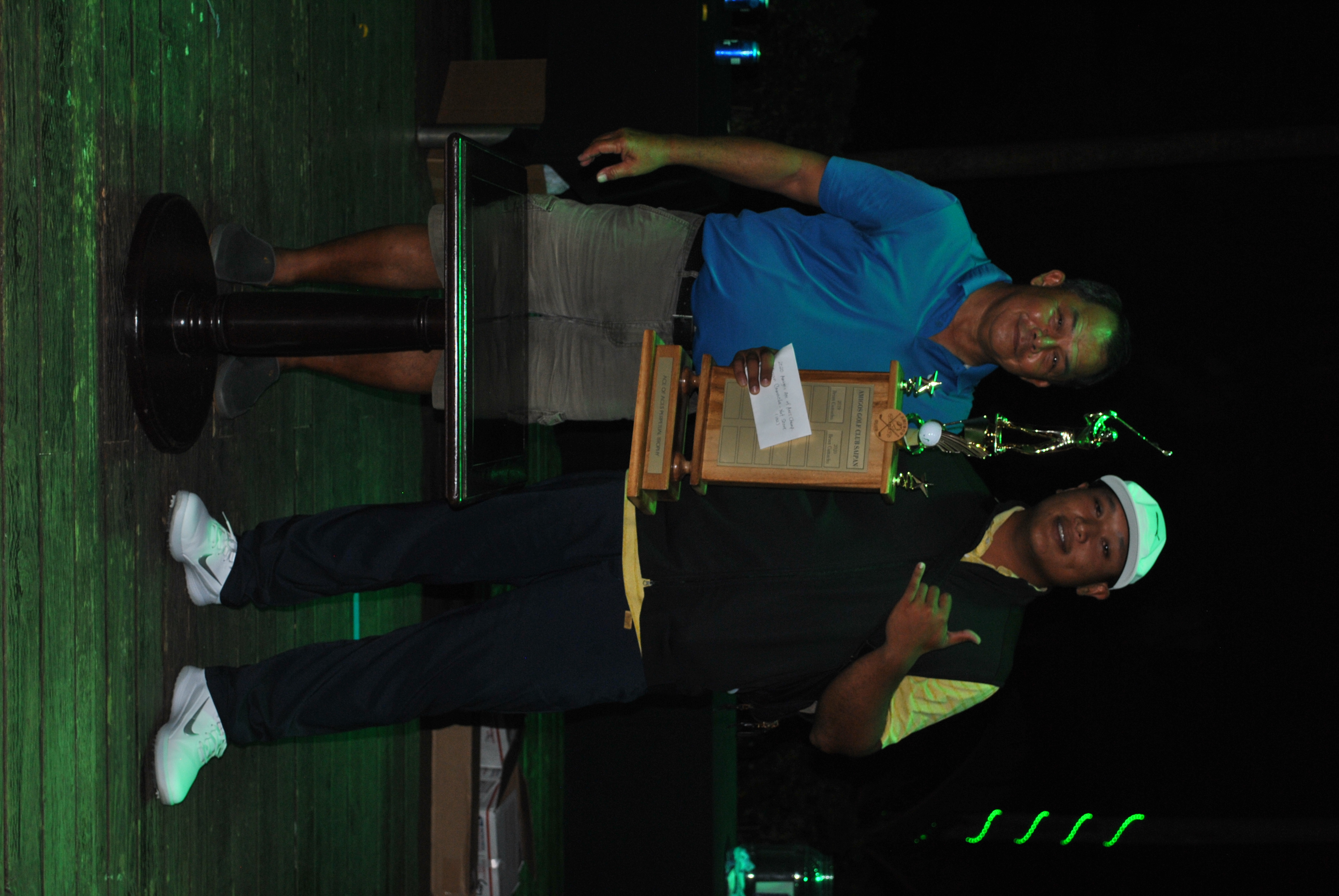 Amigos Golf Club president Joe Torres, left, poses with  Brian Camacho who holds the Ace of Aces trophy.Photo by James F. Sablan Jr.