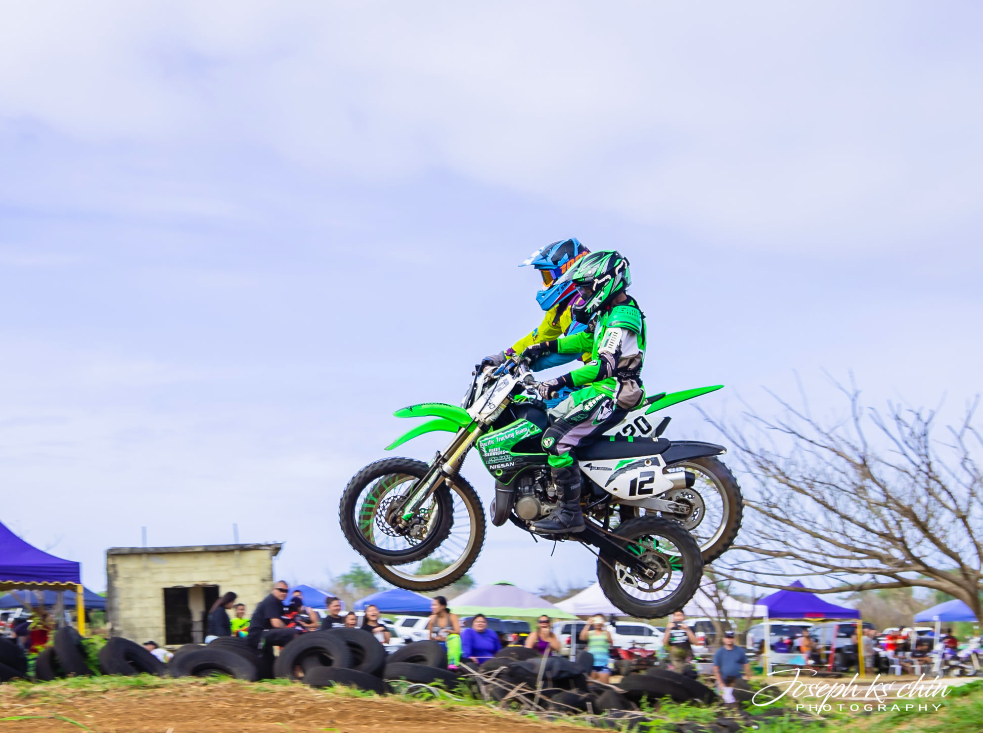 MJ Camacho gets air alongside Mari Alvarez during the Minis 1 & 2 motocross races at the Cow Town track on Sunday. Photo by Joseph Chin