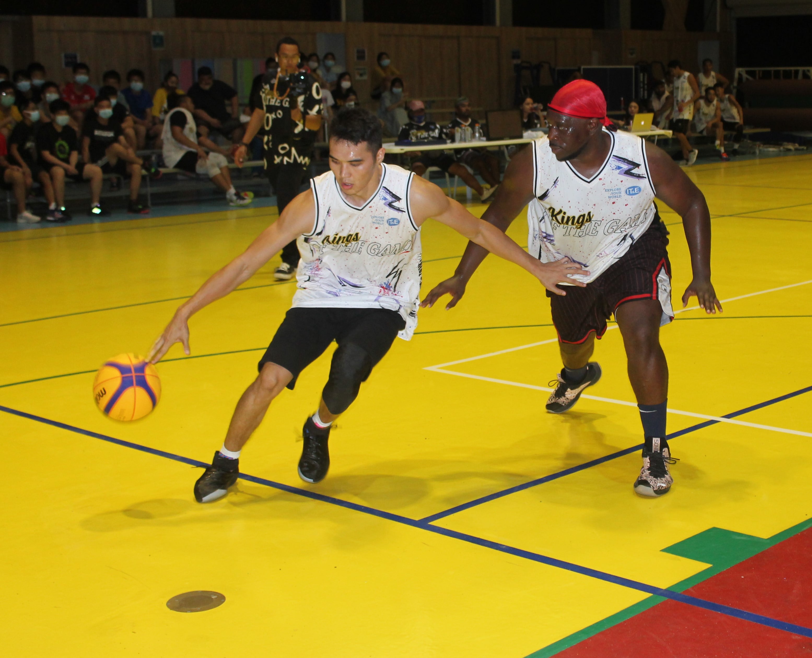 Stephen Erdene and Richard McWilliams chase after the loose ball during a Kings of the Game event at the Agape Christian School gym. Photo by James F. Sablan 