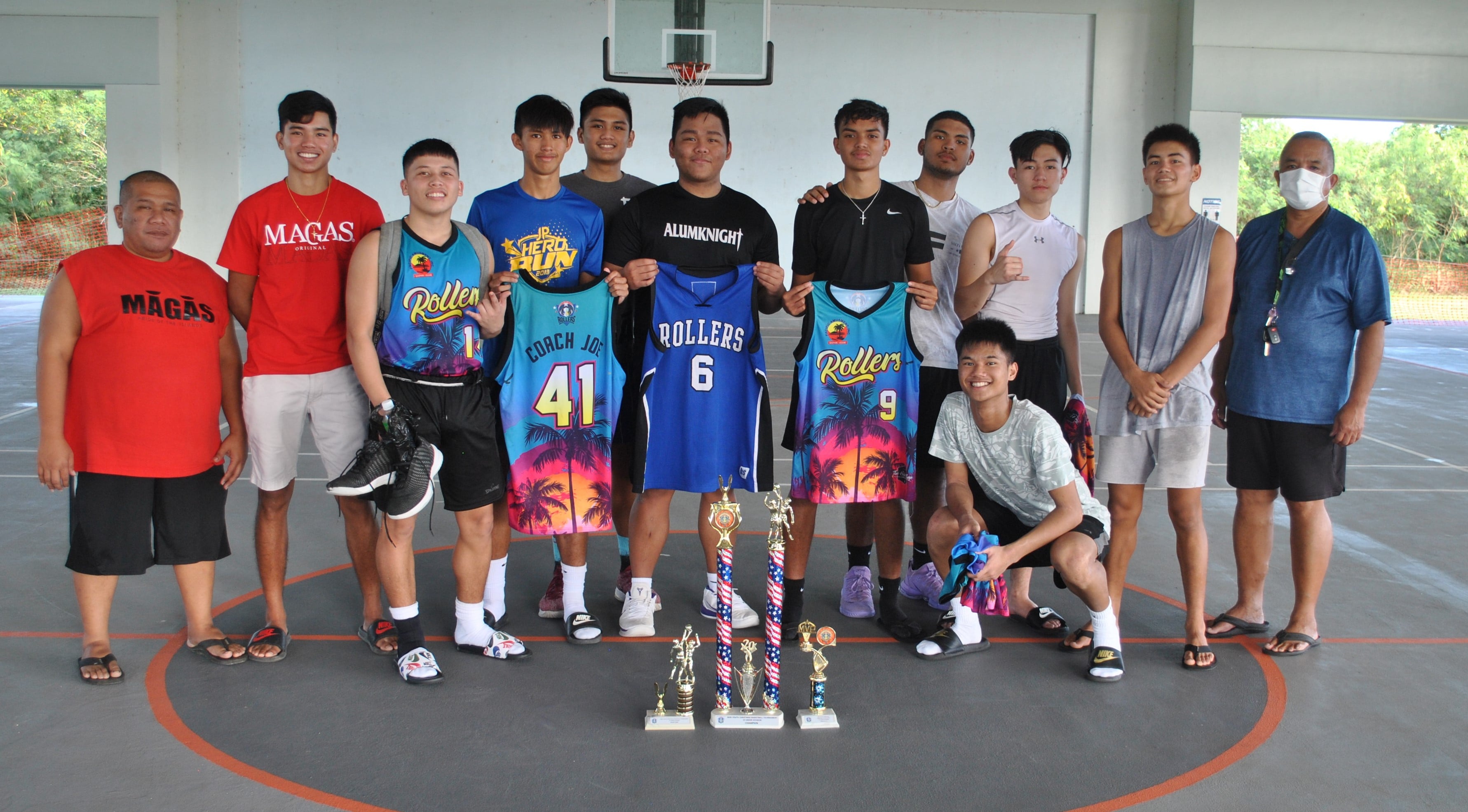 The Rollers Blue pose with their trophies following the RBA Holiday Tournament championship game at the Koblerville  gym on Saturday.Photo by James F. Sablan Jr.