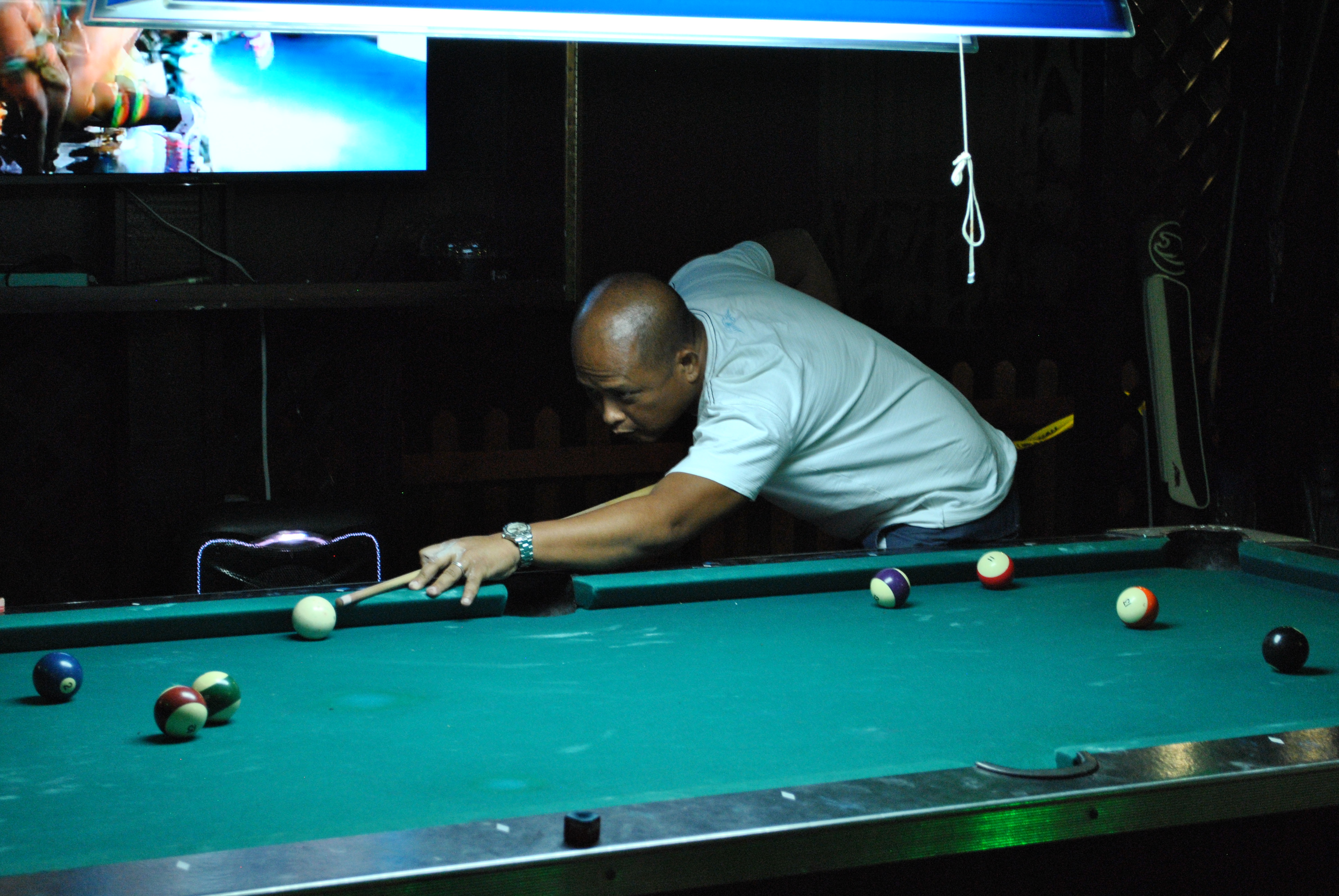 Rolly Villanueva takes a shot during a pool tournament at the New Bamboo Bar of Saipan Vegas.Photo by James F. Sablan Jr.