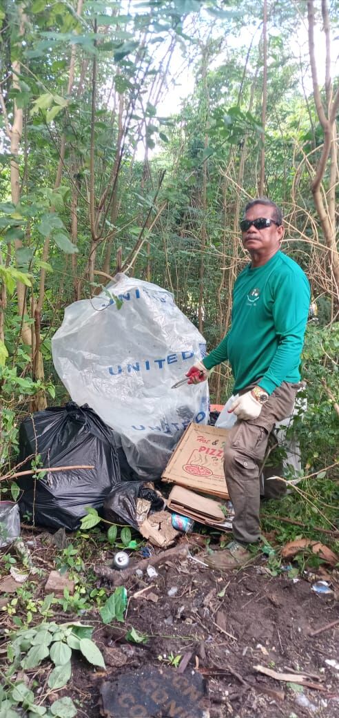 Community volunteer Max Aguon points at the household trash dumped near the Navy Hill basketball court on Friday.Contributed photo
