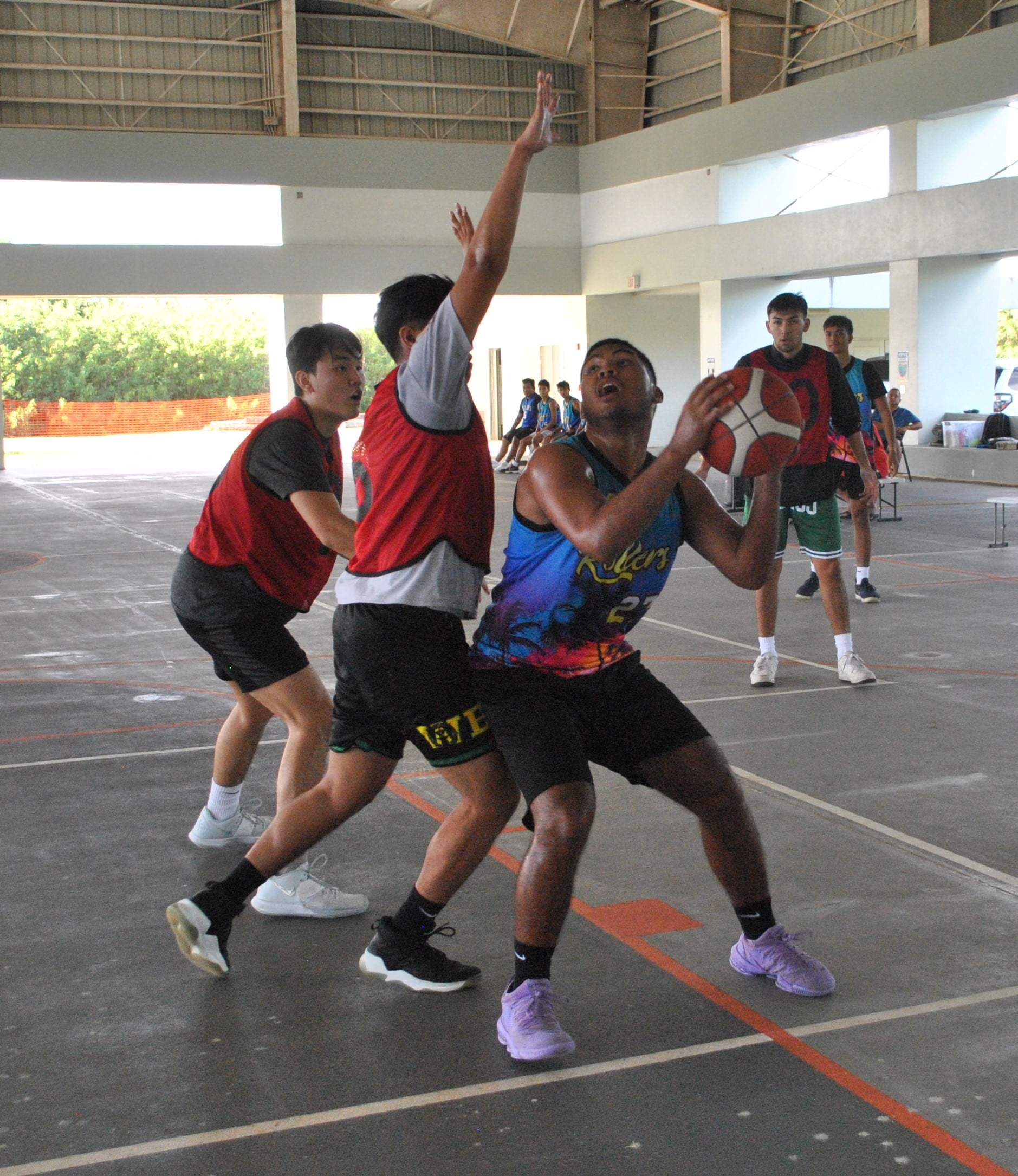 Rollers' Derrick Atalig posts up against a defender during Saturday's U19 championship game of the RBA Holiday Tournament at the Koblerville gym.Photo by James F. Sablan Jr.