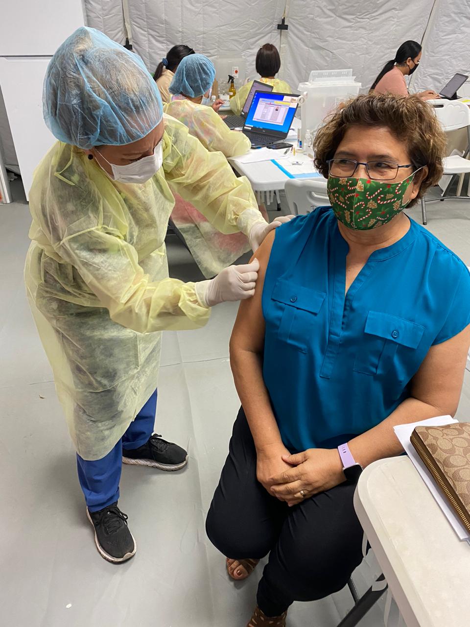 Public School System Senior Director for Instructional Services Jackie Quitugua receives the Covid-19 vaccine.Contributed photo
