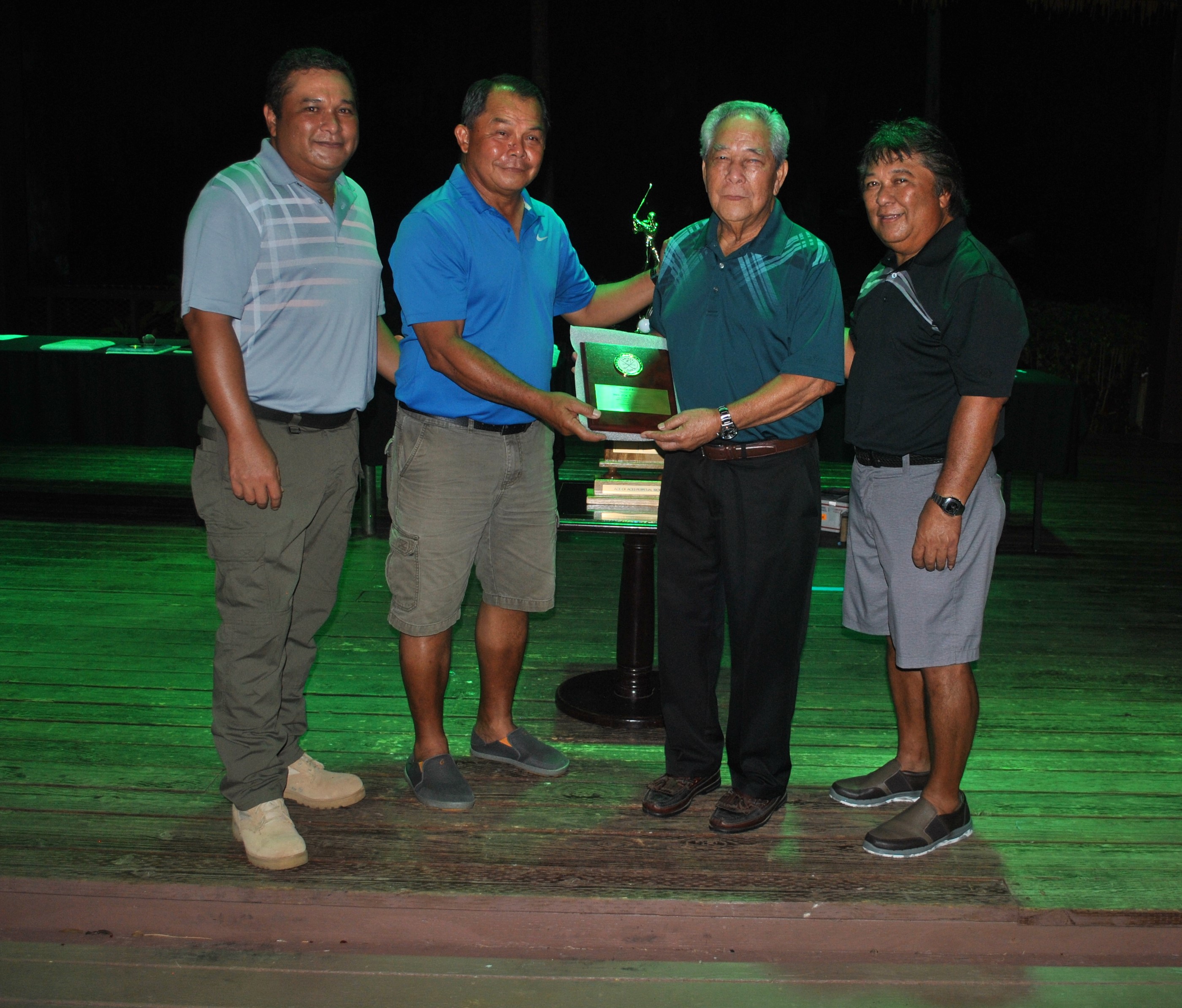 Jose T. Sablan, second right, receives an Award of Recognition from Amigos Golf Club president Joe Torres at the Fiesta Resort on Friday. Also in photo are Sablan’s sons, Frank and Joe.Photo by James F. Sablan Jr.