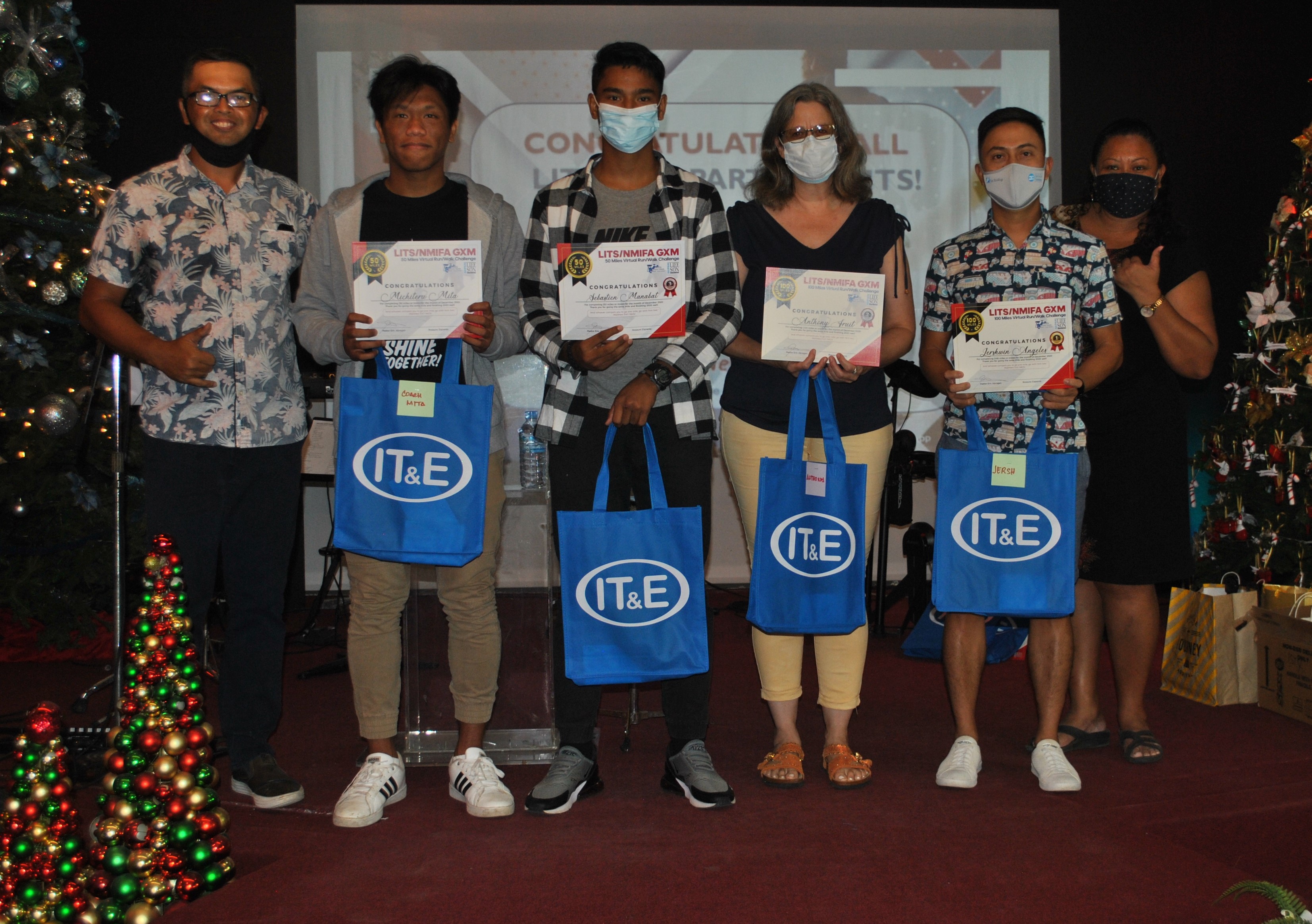 Pastor Eric Abragan, left, poses with the top winners of the NMI Football Association-Life in the Son Go the Xtra Mile Run/Walk Virtual Challenge at the Life In the Son Church on Sunday.Photo by James F. Sablan Jr