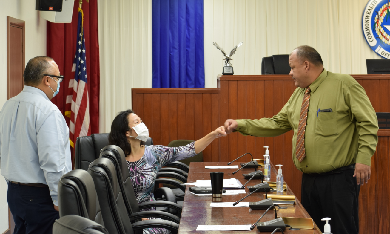 Saipan and Northern Islands Legislative Delegation Chairman John Paul Sablan, right, and House Minority Leader Tina Sablan greet each other with a fist bump while Speaker Blas Jonathan Attao looks on before the start of the  delegation’s final session on Tuesday.Photo by Emmanuel T. Erediano