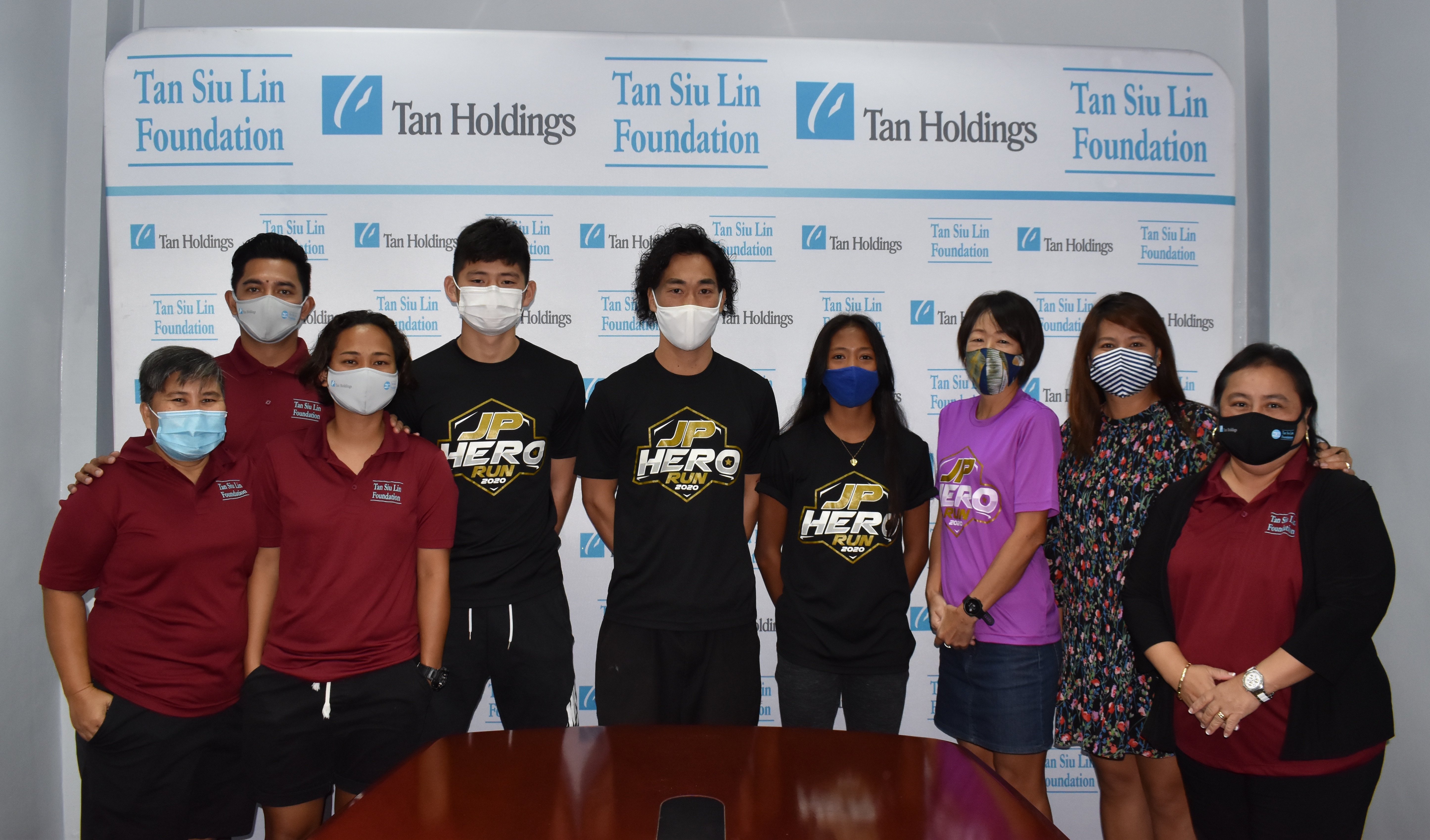 Winners in the 10K race of the JP Hero Run Virtual Edition pose with organizers of the event, which was hosted by the Tan Siu Lin Foundation, during the awards ceremony Wednesday in Garapan.Contributed photo
