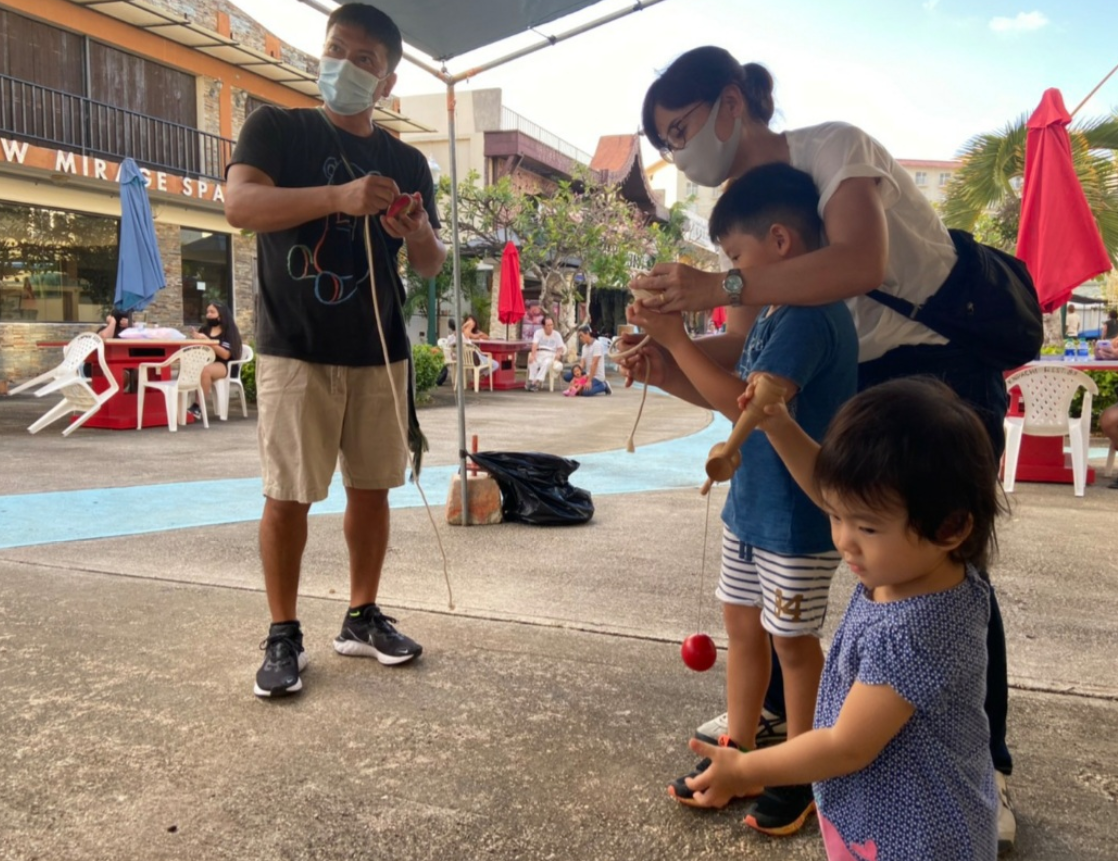 Children and their parents try playing with the kendama, a traditional Japanese skill toy.Contributed photo