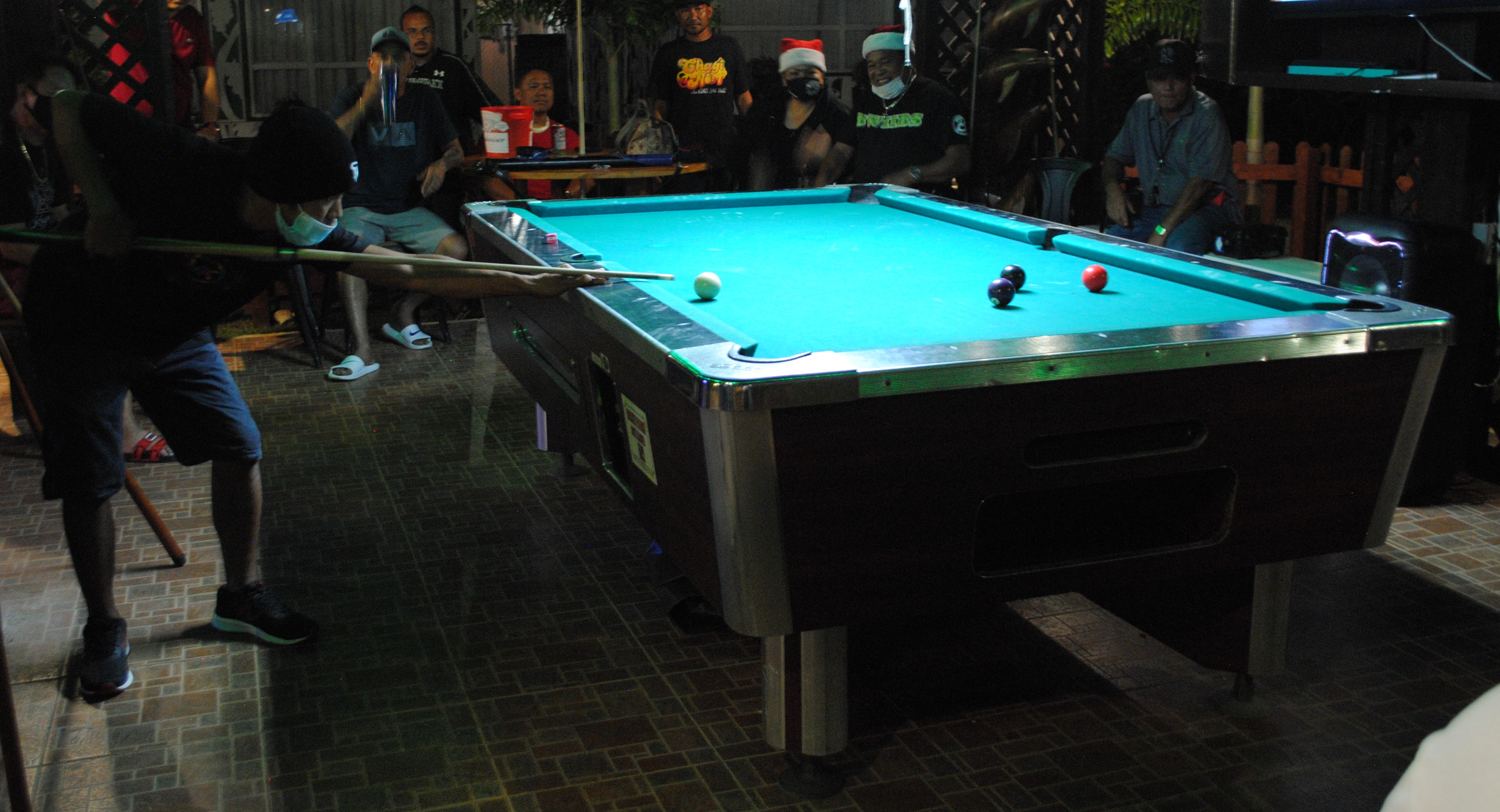 Jess Farinas aims for an 8-ball finish during a pool tournament at the New Bamboo Bar of Saipan Vegas.Photo by James F. Sablan Jr.