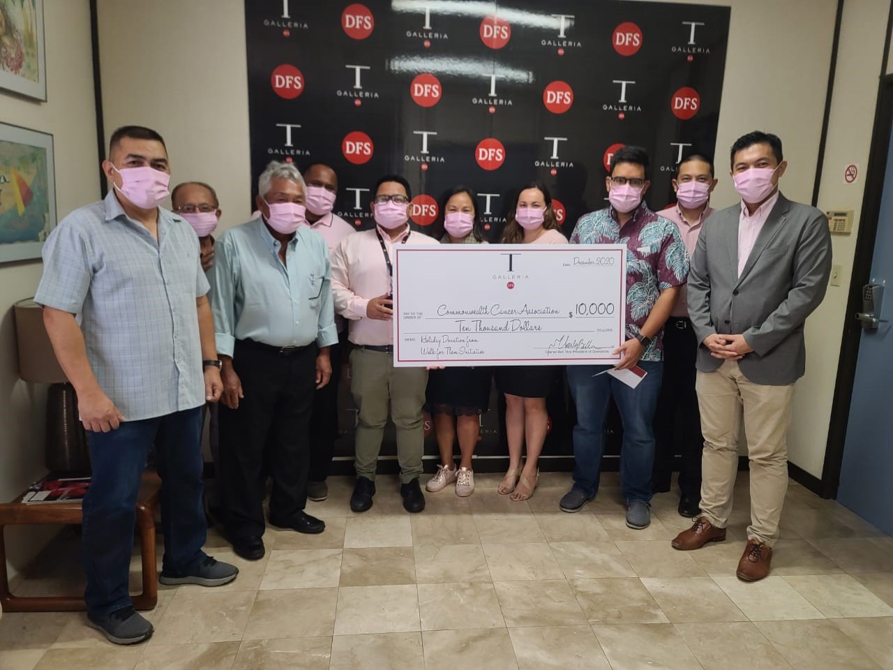 DFS managers join Commonwealth Cancer Association board members at the check presentation at T-Galleria on Jan. 7. 2021.  Pictured from left: Jack Salas, loss prevention manager; Cesar Dumatol, CCA board member; Juan Babauta, CCA executive director; Aaron Yobech, product support assistant; Jomari Pico, AGM of sales; Esther Ada, HR manager; Jamika Taijeron, shop operations manager; Bo Palacios CCA president; Andy Qin, product sales manager; and Billy Cheung, acting GM.  Not pictured is Mark Moss, facilities manager.Contributed photo