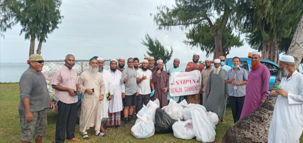 Saipan Muslim Community members with community volunteers Max Aguon and Akiki Alexander pose for a group photo at the Kilili pavilion in Susupe following a cleanup activity on Beach Road Saturday.Contributed photo
