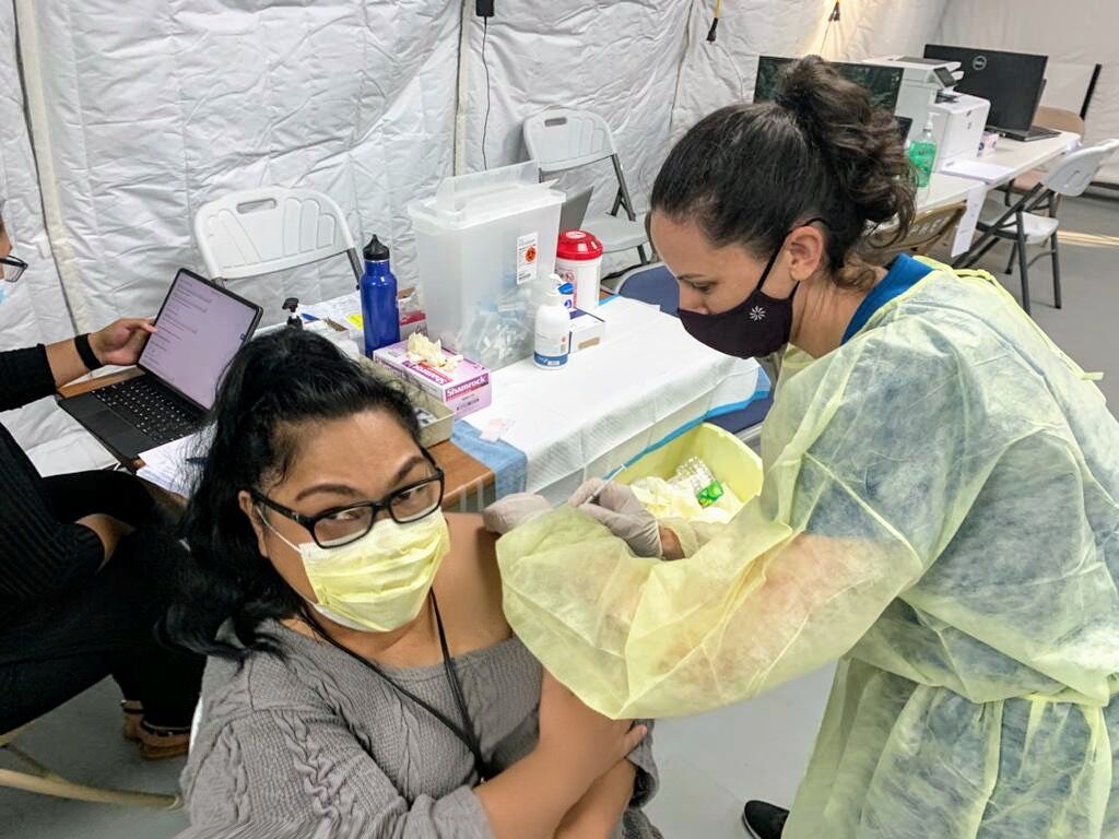 Outgoing Board of Education chairwoman and IT&E customer service and government relations manager Janice Marie A. Tenorio receives the Covid-19 vaccine.Contributed photo