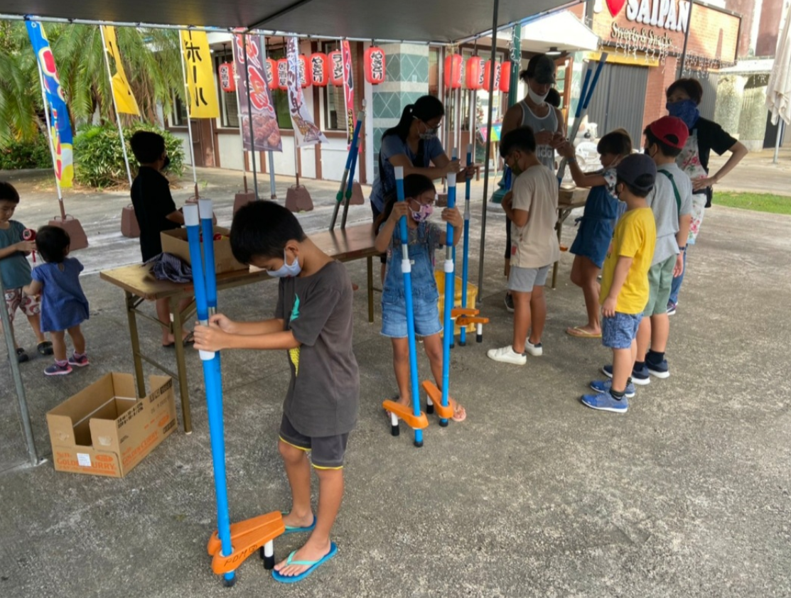Children check out the takeuma, the Japanese walking stilts.Contributed photo