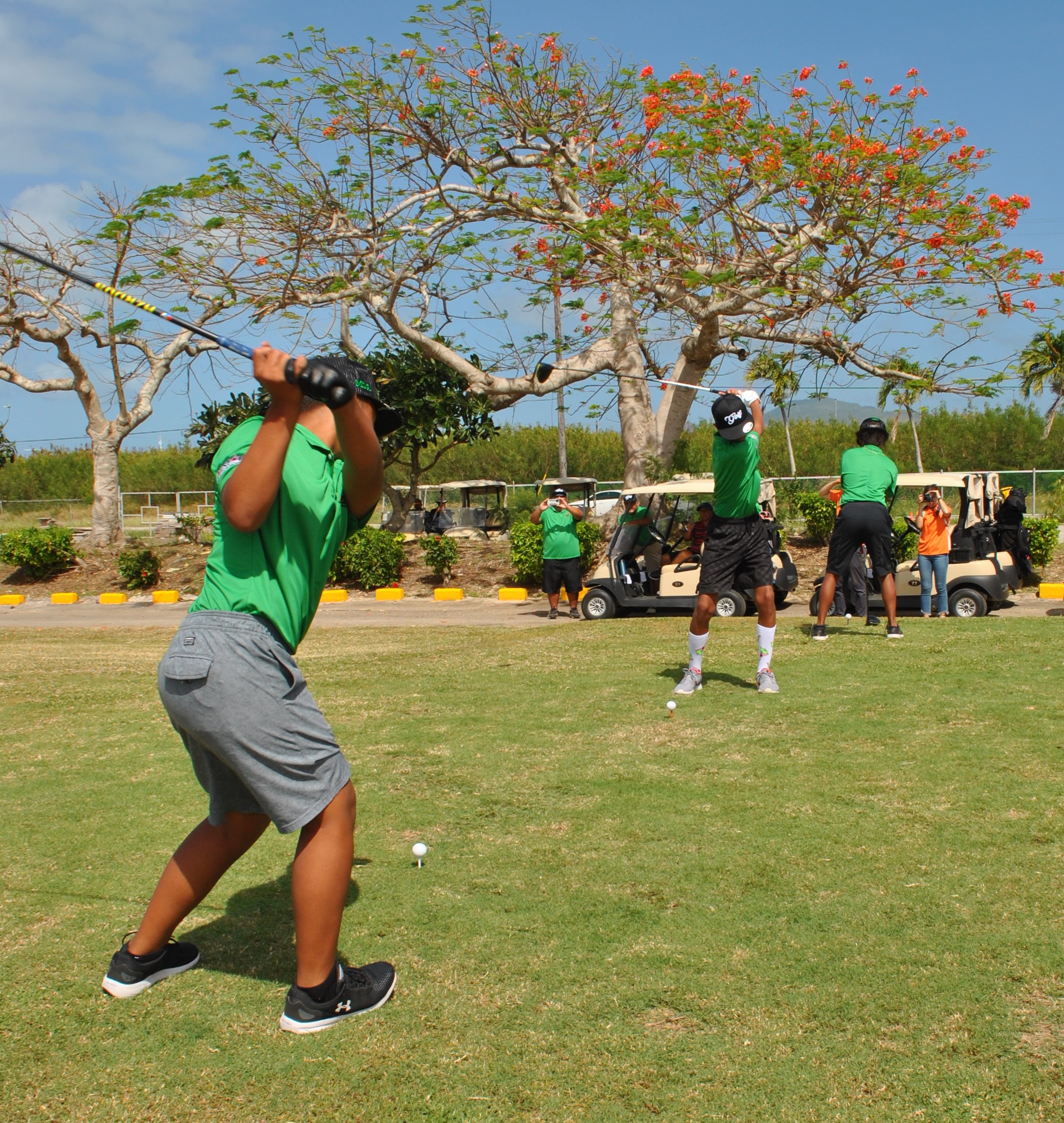 Junior golfers make the opening swings before the start of the golf invitational at the Coral Ocean Golf Resort on Thursday.Photo by James F. Sablan Jr.
