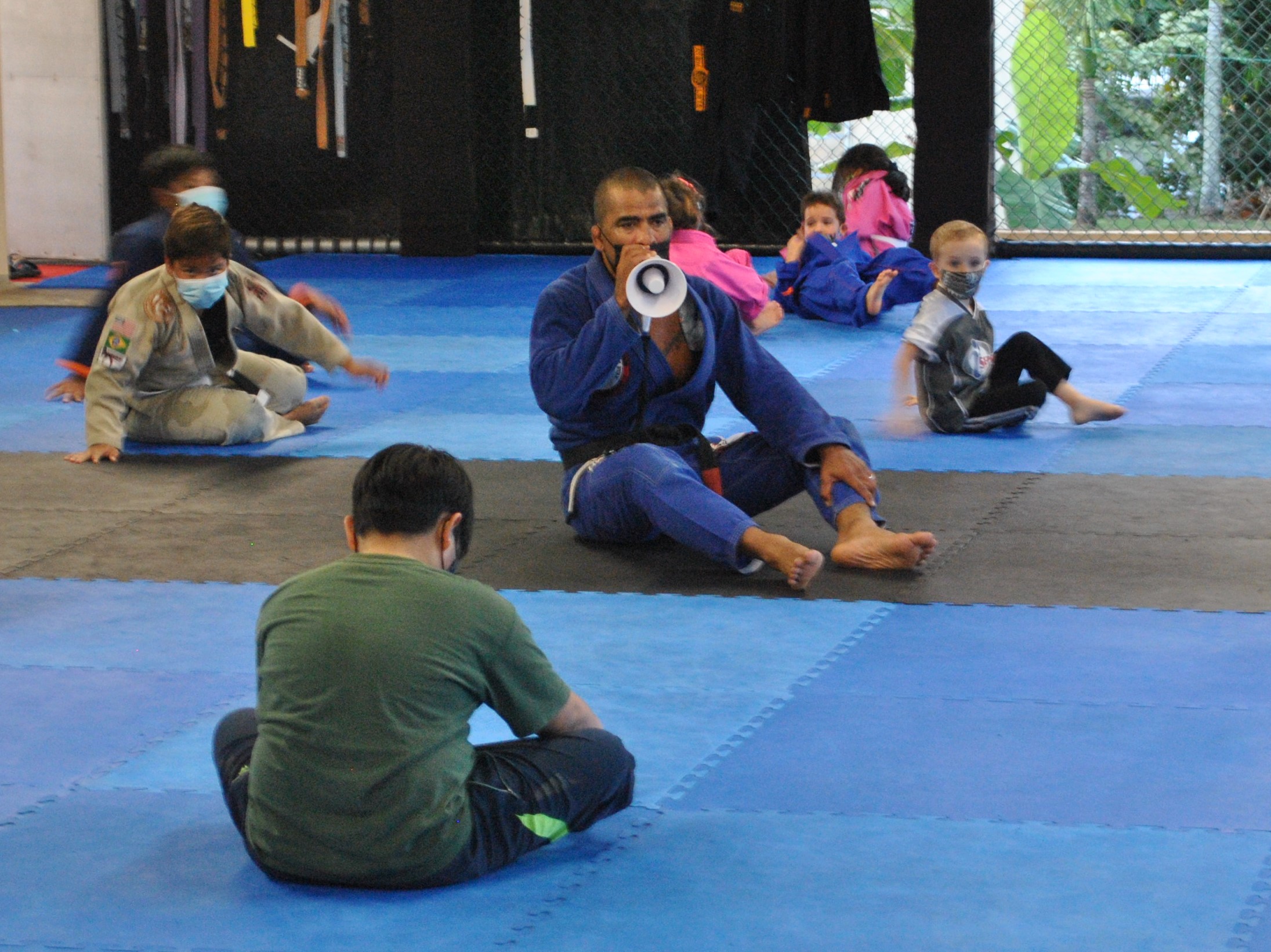 Cuki Alvarez speaks into a mini-megaphone as he conducts a Kids BJJ class at the Trench Tech Gym on Tuesday.Photo by James F. Sablan Jr.