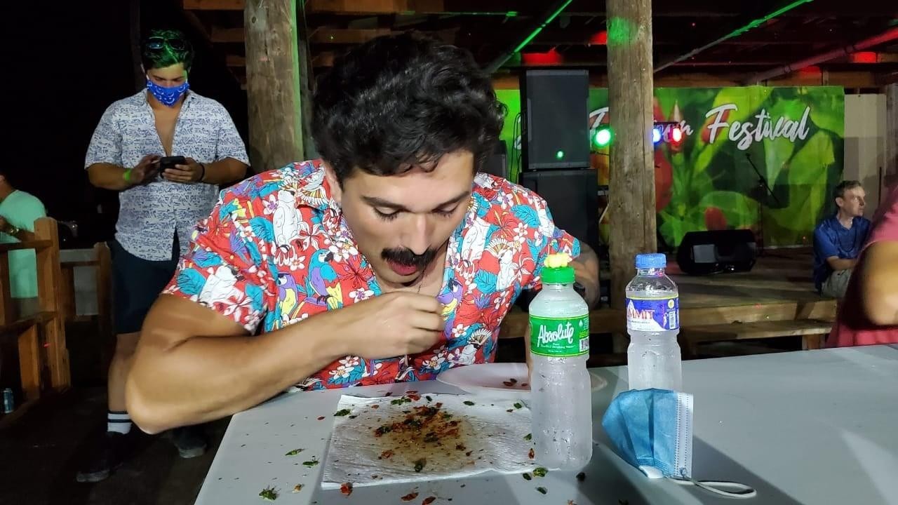 U.S. Navy Seabee Ricardo Carrazco, who is from Nebraska, chomps his way through 100 “donne sali” peppers on Feb. 13, 202, to win 1st place in the Hot Pepper Eating Contest (Male Category) during the 17th Annual Tinian Hot Pepper Festival.MVA photo
