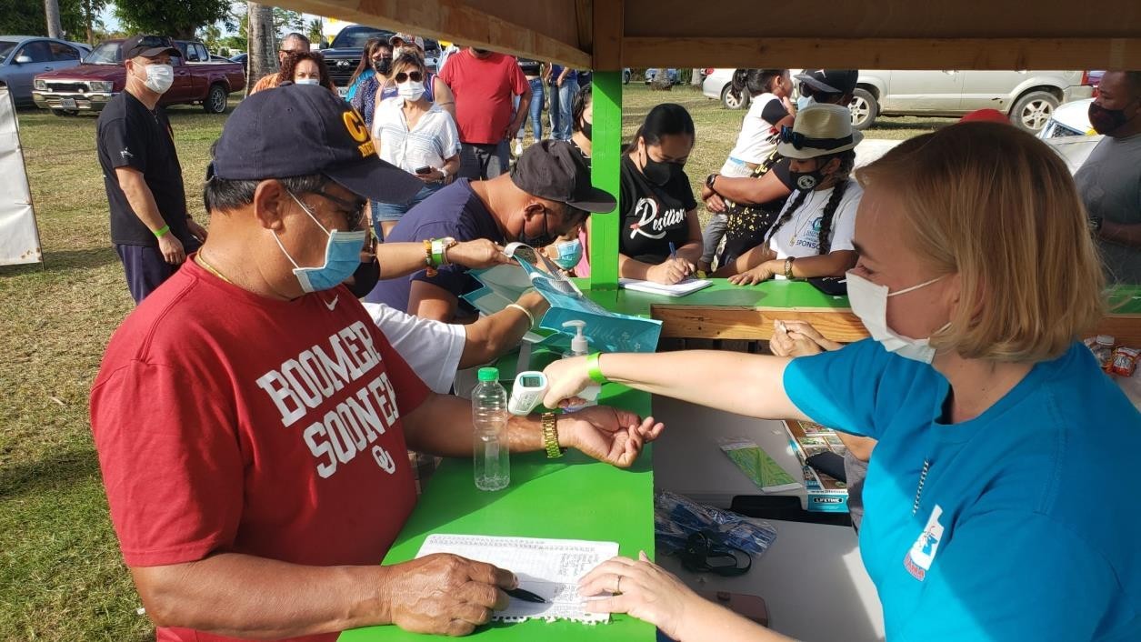 Upon entry, attendees of the 17th Annual Tinian Hot Pepper Festival on Feb. 13-14, 2021 receive temperature checks and leave their contact information for contact tracing.MVA photo