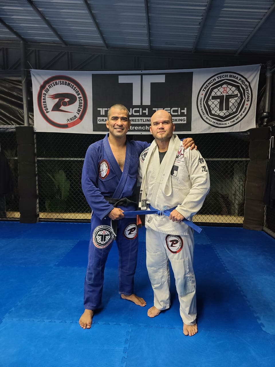 Cuki Alvarez, left, poses with Stanley Iakopo who received his blue belt on Tuesday at the Trench Tech Gym.Contributed photo