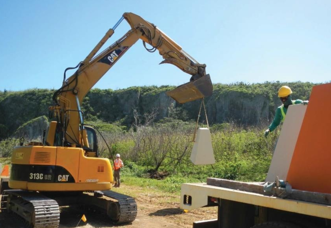 Contractors install concrete bollards to delineate the Chiget Beach access pathway at the site in Tinian on Jan. 19, 2021. Contributed photo