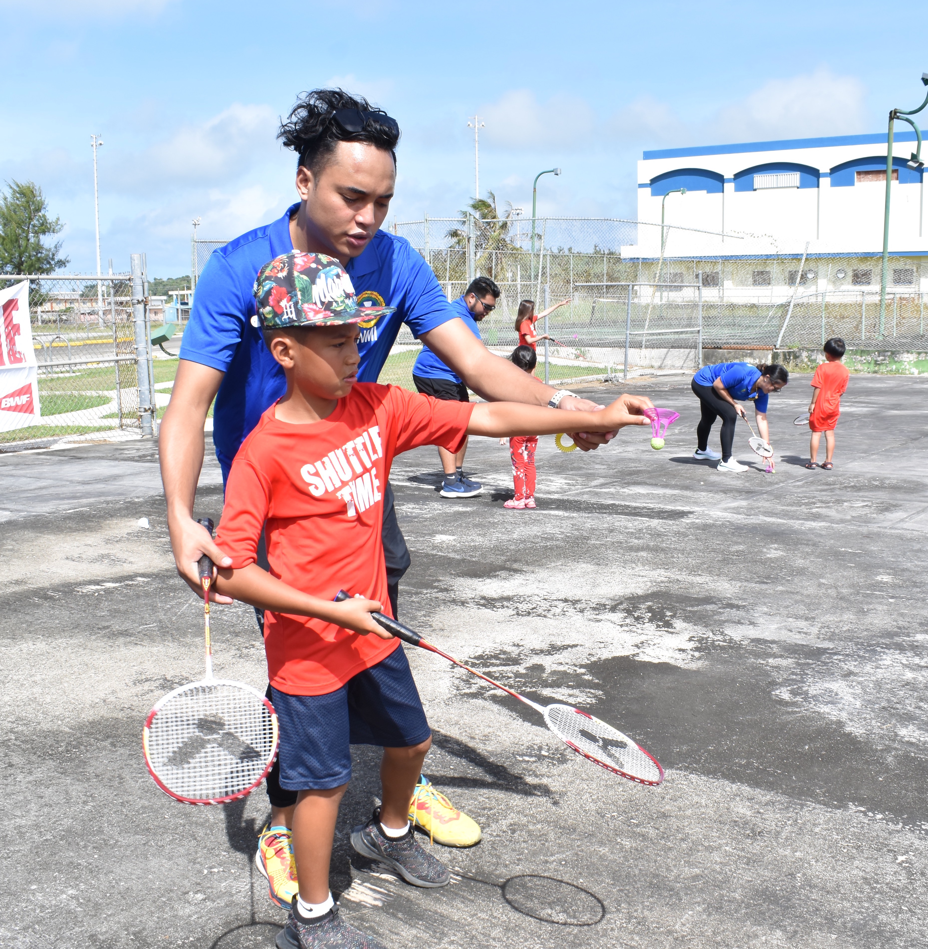 CNMI National Team player Nate Guerrero assists Tinian Elementary School’s Galyo Untalan during Northern Marianas Badminton Association’s Shuttle Time session at the Tinian Youth Center last weekend.Contributed photo