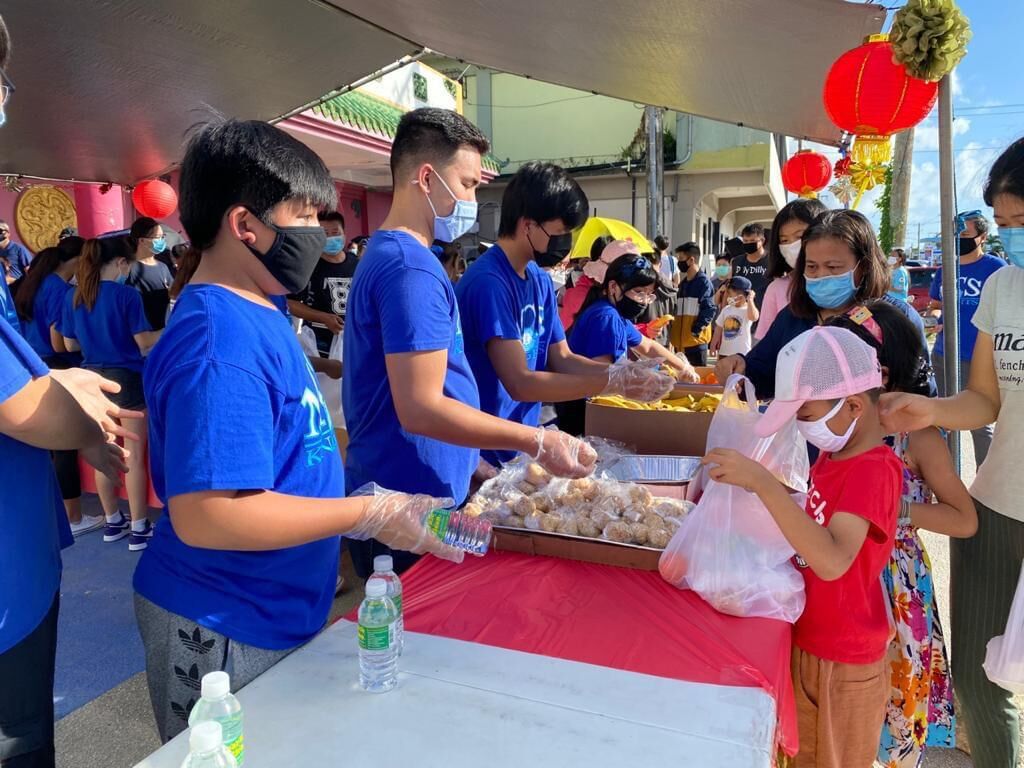 Volunteers from the Mount Carmel School National Honor Society distribute hot meals and treats to residents.Contributed photo