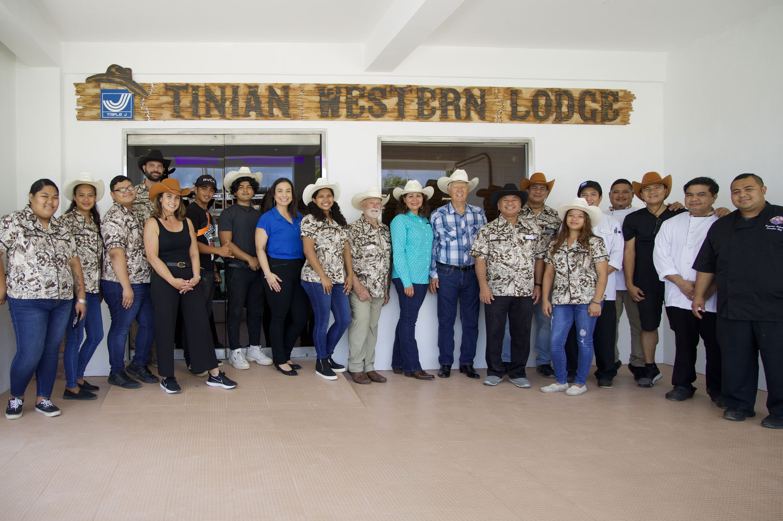 Robert H. Jones, Triple J chairman of the board and chief executive officer, poses with other Triple J executives and personnel at the Tinian Western Lodge, one of the new Triple J businesses that opened on Tinian. The others are the Hertz Rent-A-Car office, and the Bar-K-Diner & Drive-In. Jones said Triple J is also building a Five Star Wholesale store which will open in April. Triple J photo