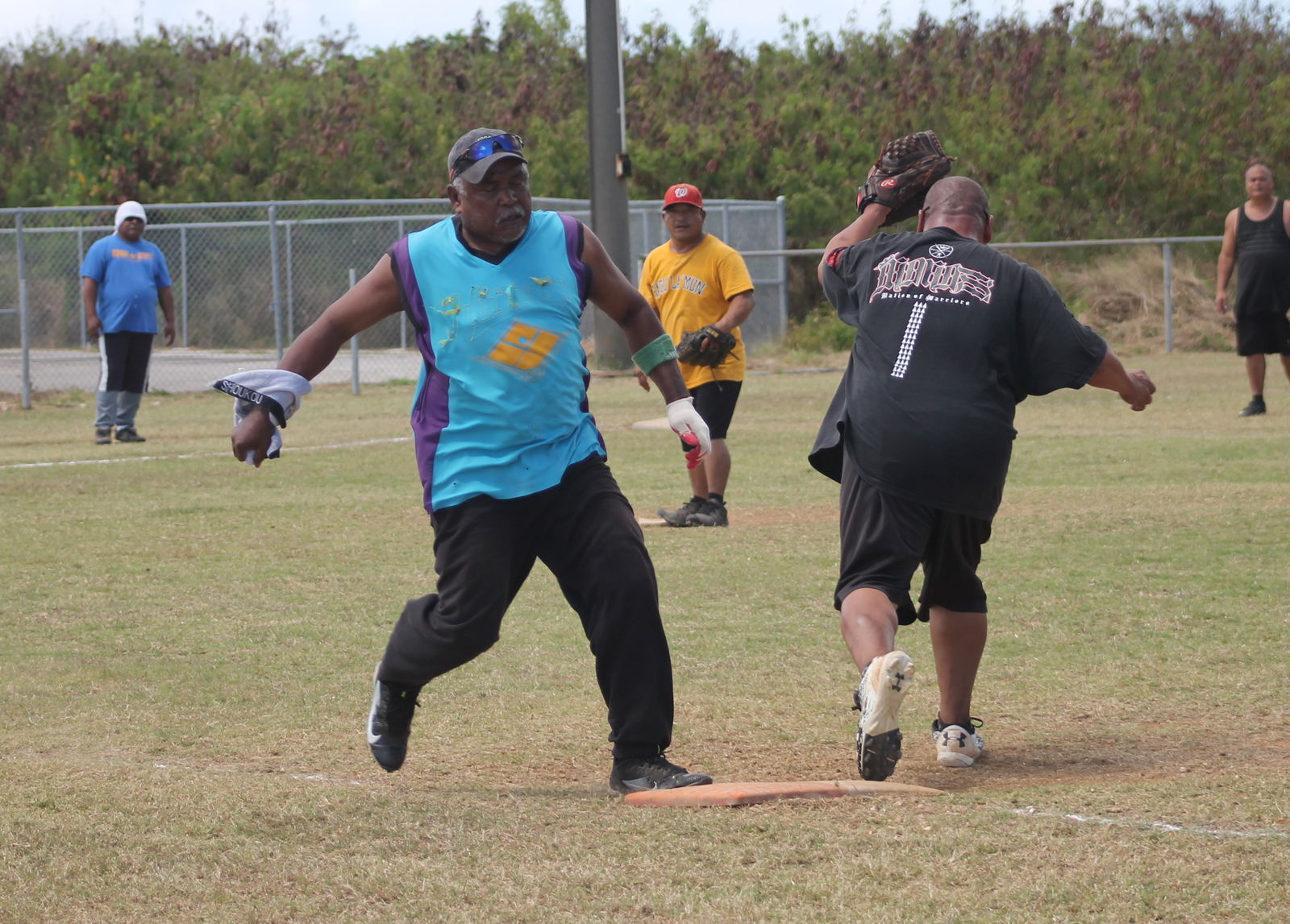 PeLeLiu's Mabel Ngrigemelas reaches first base safely during a Belau Amateur Softball League game at the Dandan baseball field.Photo by James F. Sablan Jr.