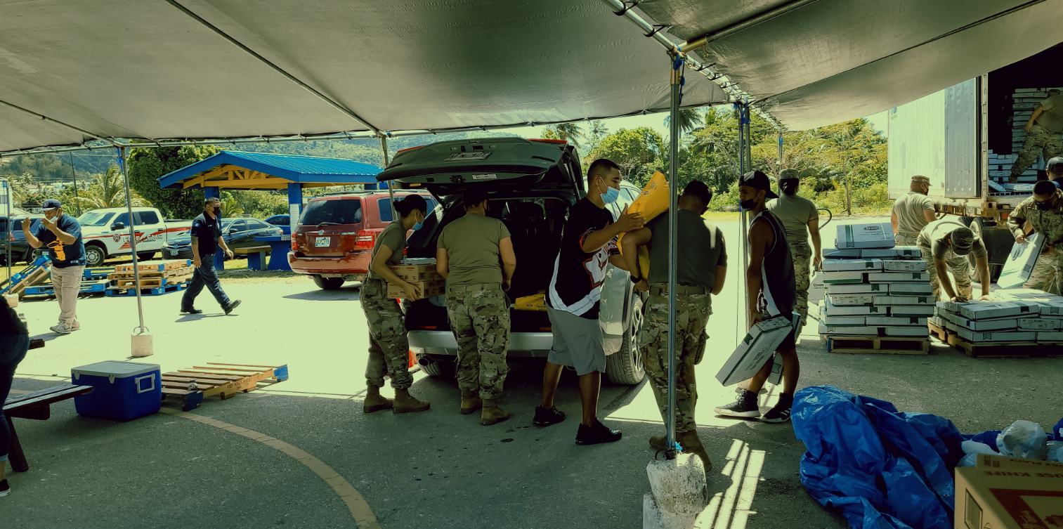 Army Reservists load food packages into the trunk of an SUV at the Garapan Fishing Base on Saturday.Photo by Bryan Manabat