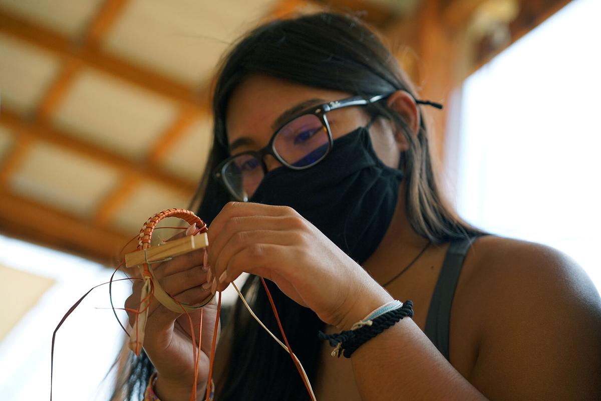 Ahmyia Cacapit, a returning student of Roquin-Jon Siongco, adds the finishing touches to her woven bracelet during a workshop at Sagan Kotturan Chamoru Cultural Center in Tumon, Guam on Saturday.Photo by Haruo Simion/The Guam Daily Post