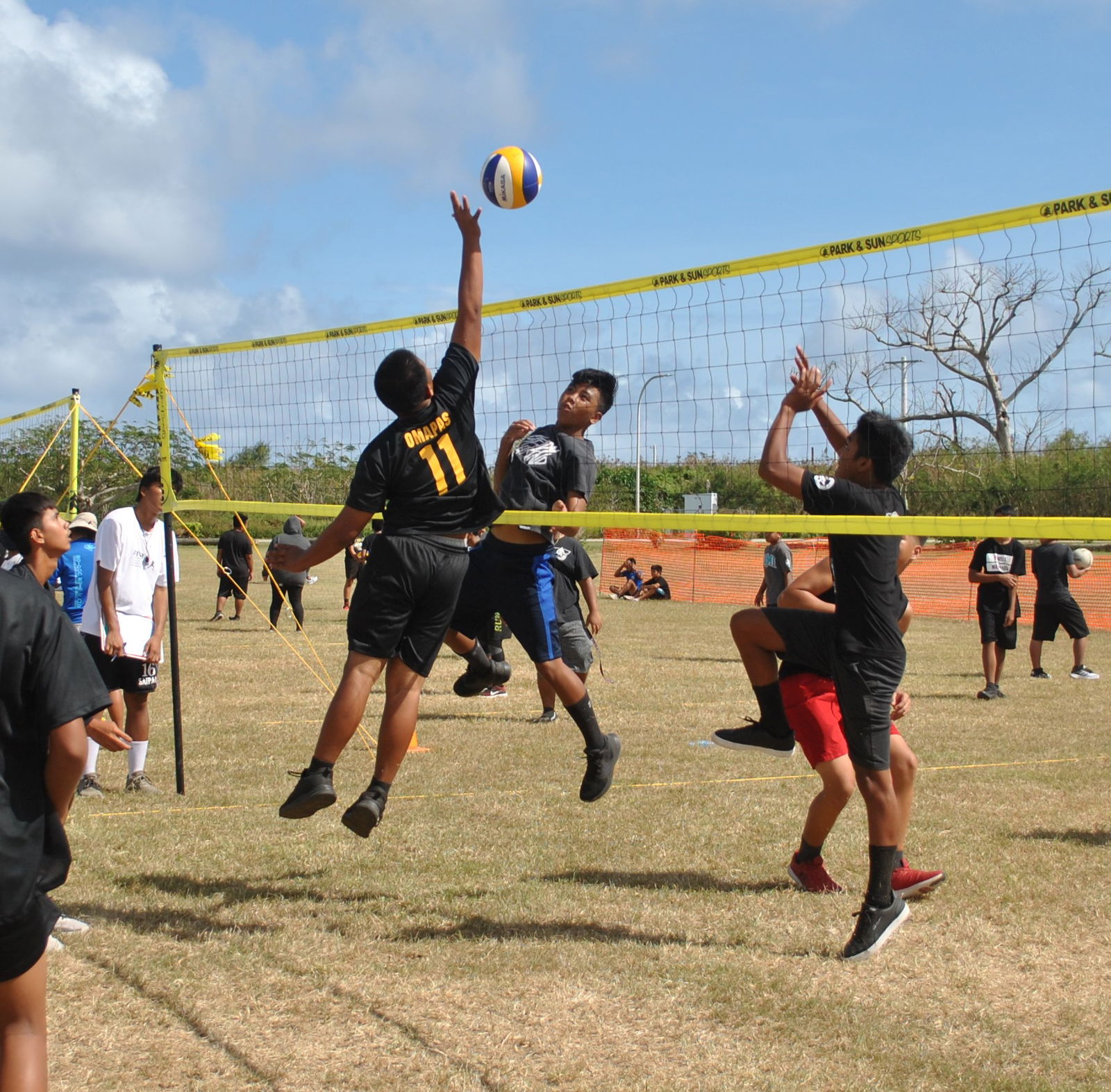 Tanapag Middle School’s Kaehi Omapas reaches for the block during a PSS 4v4 Boys Grass Volleyball League game at the CPA Airport Field on Monday.Photo by James F. Sablan Jr.