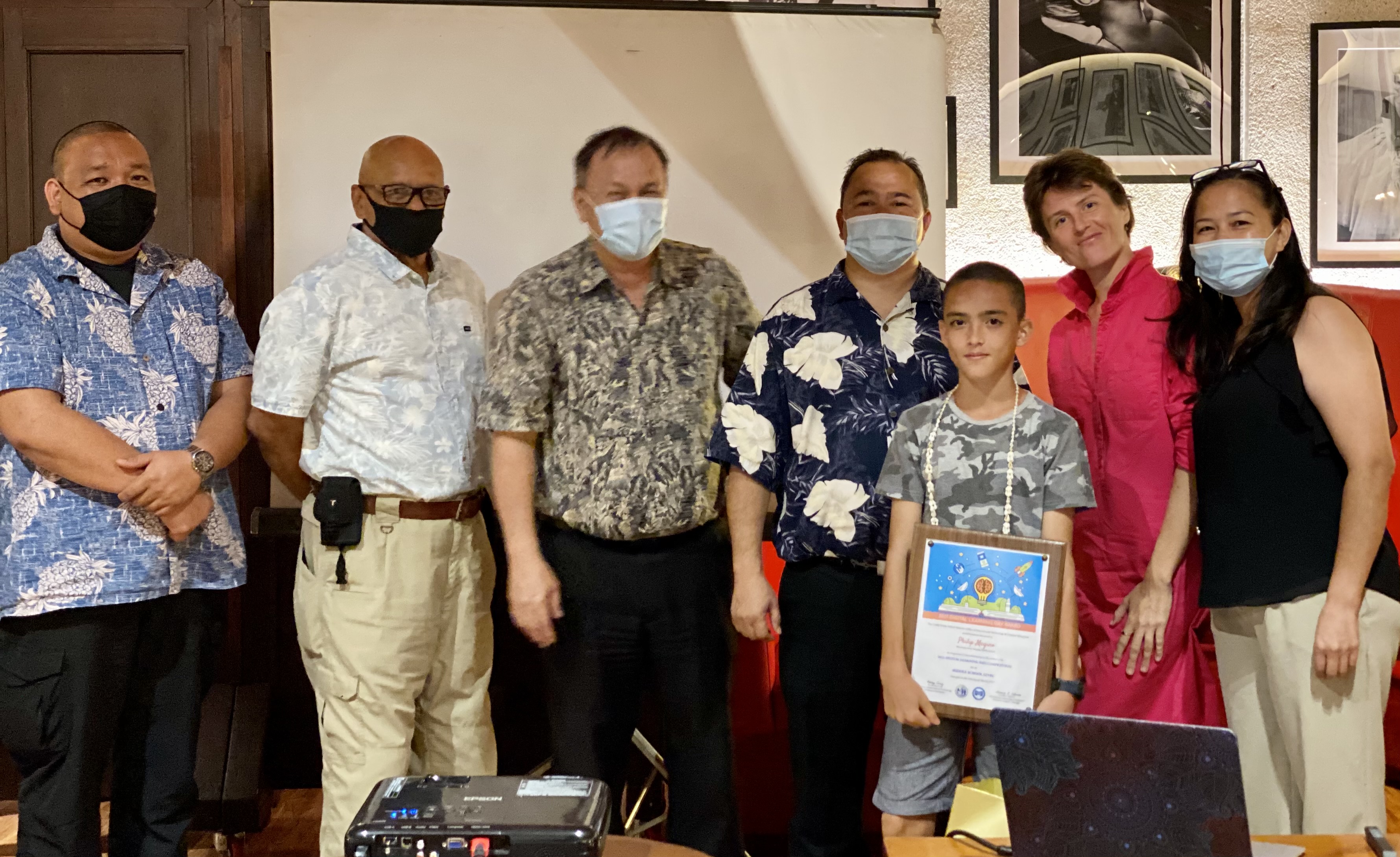 Tanapag Middle School student Philip Megino  topped the middle school category. Also in photo are his mother, school principal Hilda Rios, Commissioner of Education Dr. Ada, Board of Education Chairman Andrew L. Orsini, BOE Vice Chairman Herman Atalig, and Associate Commissioner for Administrative Services Eric Magofna.PSS photo