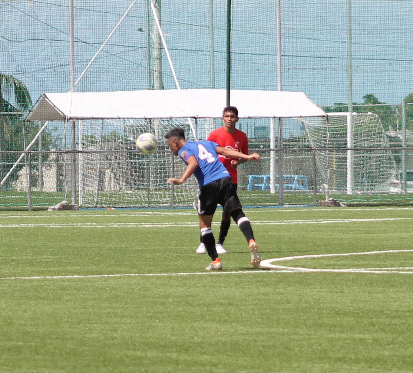 Old B Bank's Suguru Takahashi intercepts the ball with a header.