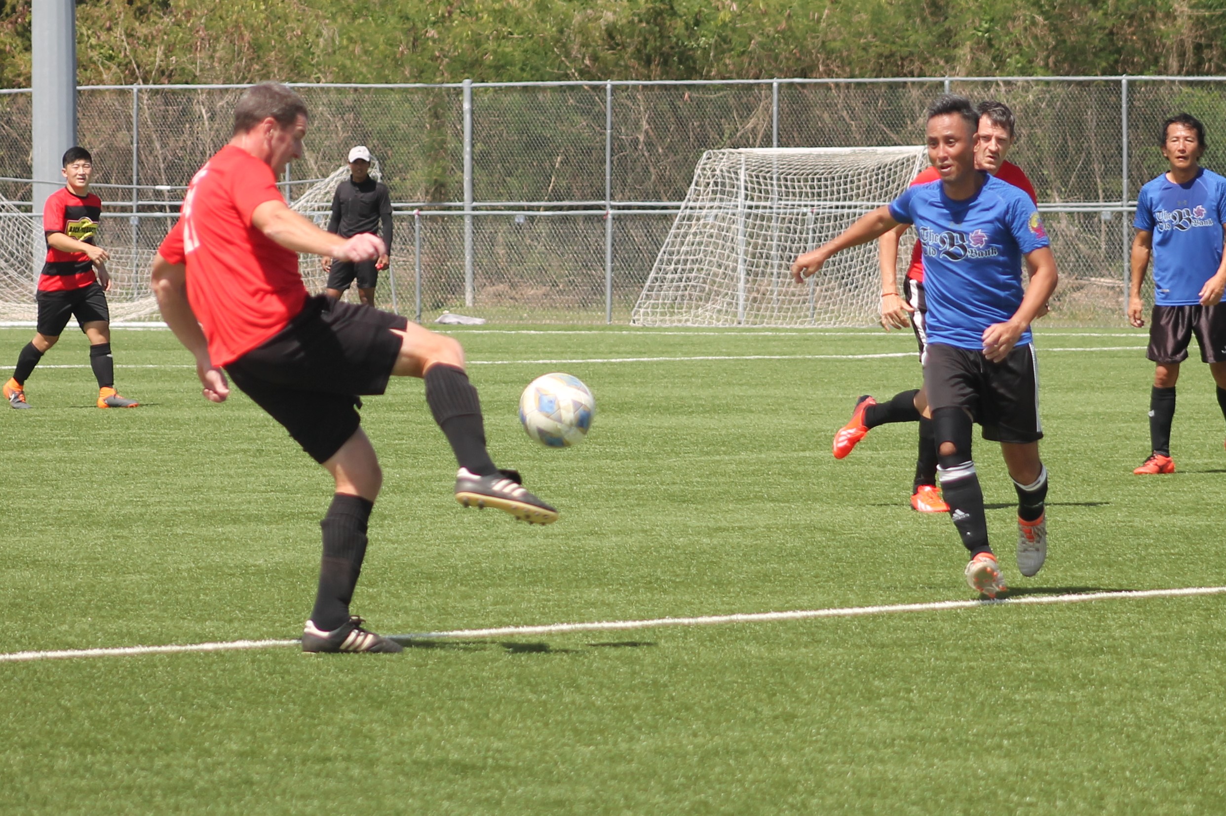 Paire Football Club’s Travis Spaeth attempts the lob pass during a  Men's M-League Spring 2021, Division A game on Sunday at the NMI Soccer Training Center.Photo by James F. Sablan Jr.