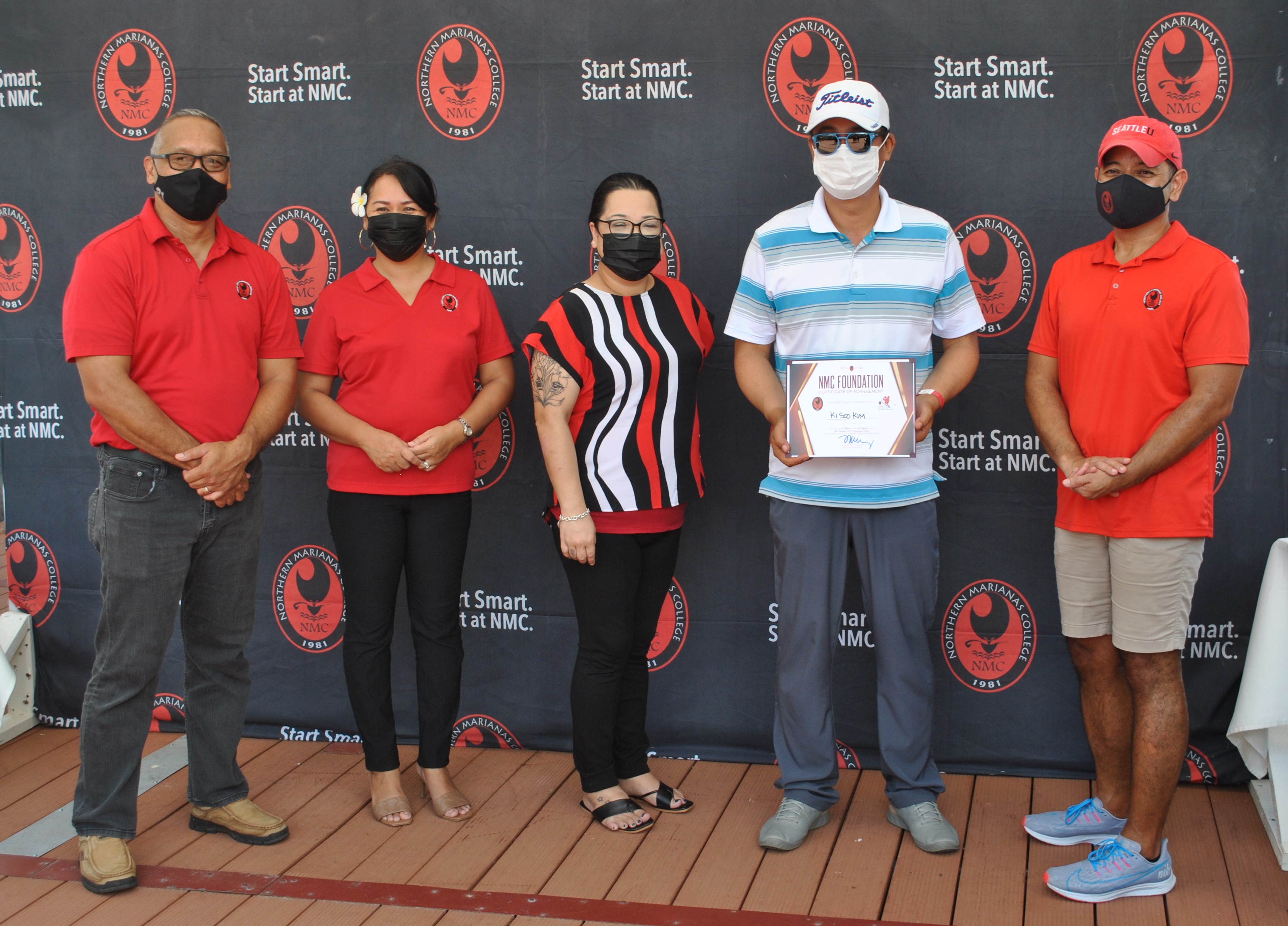 Ki Soo Kim, 2nd right, the A Flight winner of the 16th Annual NMC Foundation Golf Tournament at LaoLao Bay Golf & Resort on Saturday, poses with Northern Marianas College officials during the awards ceremony.Photo by James F. Sablan Jr.