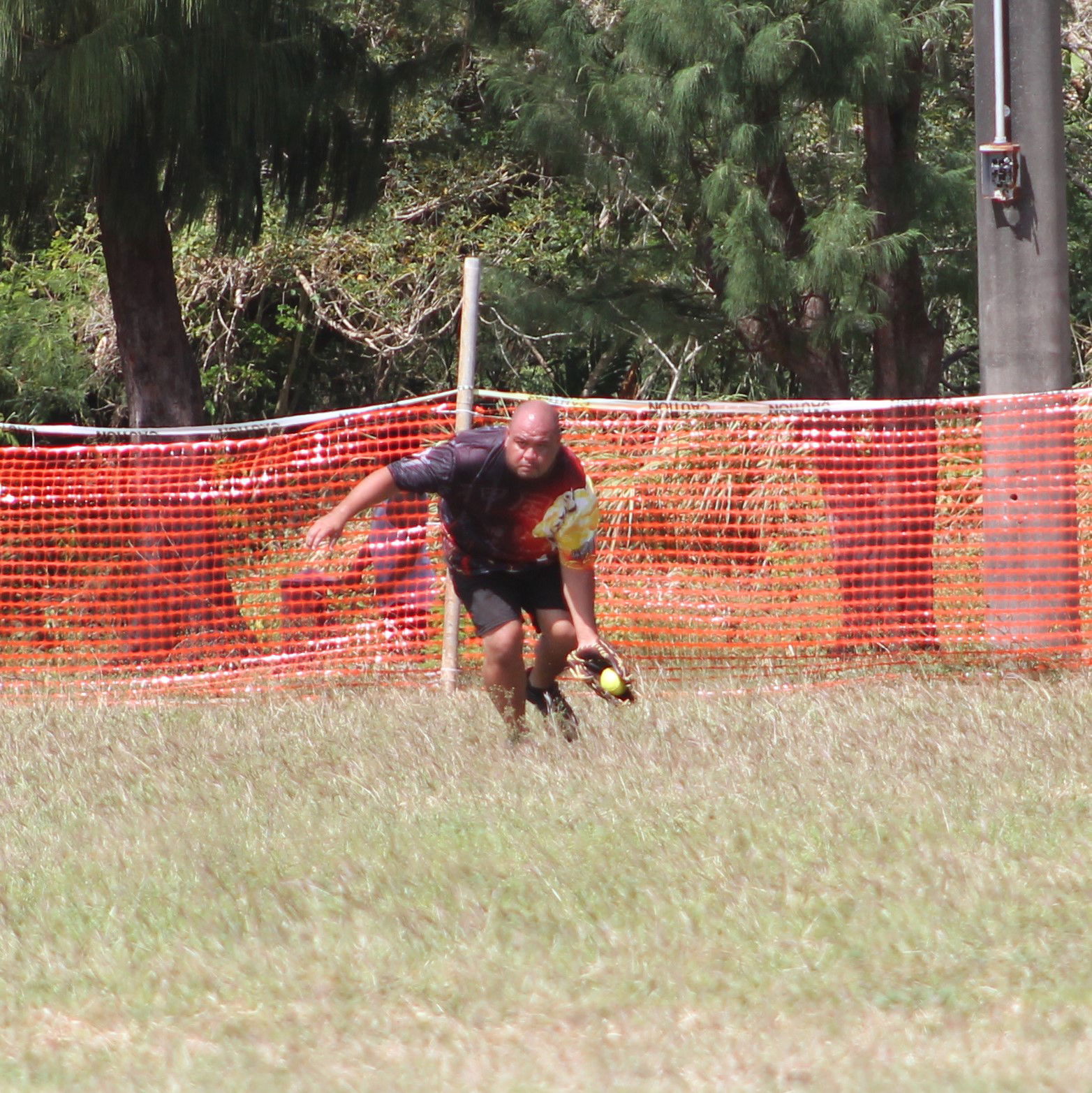 Mommy Charu's Derek reaches out to secure the ball on the outfield during a Belau Amateur Softball League game at the Dandan baseball field.Photo by James F. Sablan Jr.