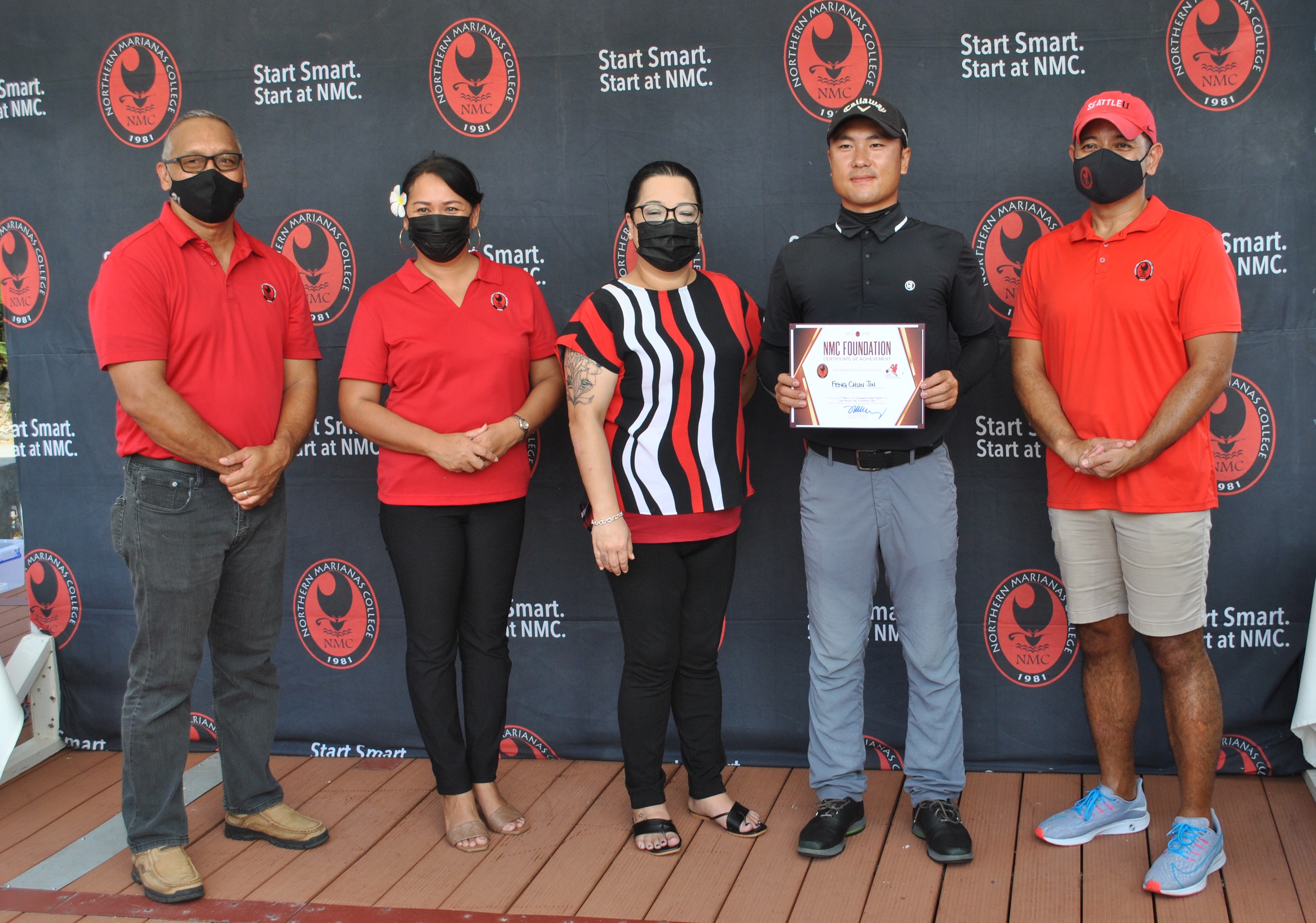 Feng Chun Jin, 2nd right, poses with Northern Marianas College officials after topping the Championship Flight of the 16th Annual NMC Foundation Golf Tournament at LaoLao Bay Golf & Resort on Saturday.Photo by James F. Sablan Jr.