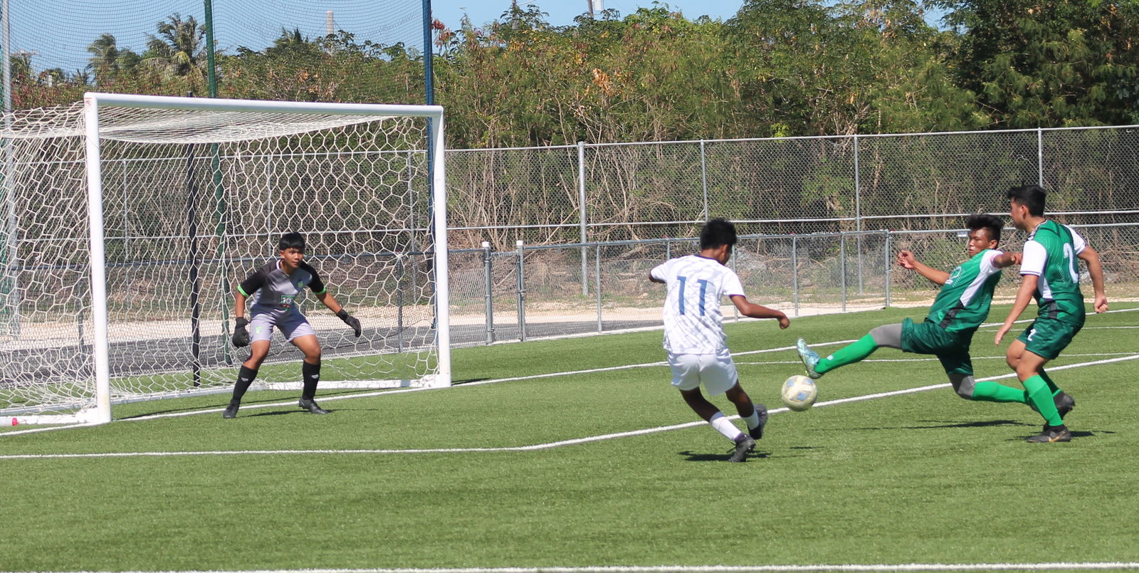 U18 NT B's Ariel Narvaez takes the shot as TanHoldings’ defenders go for a deflection.