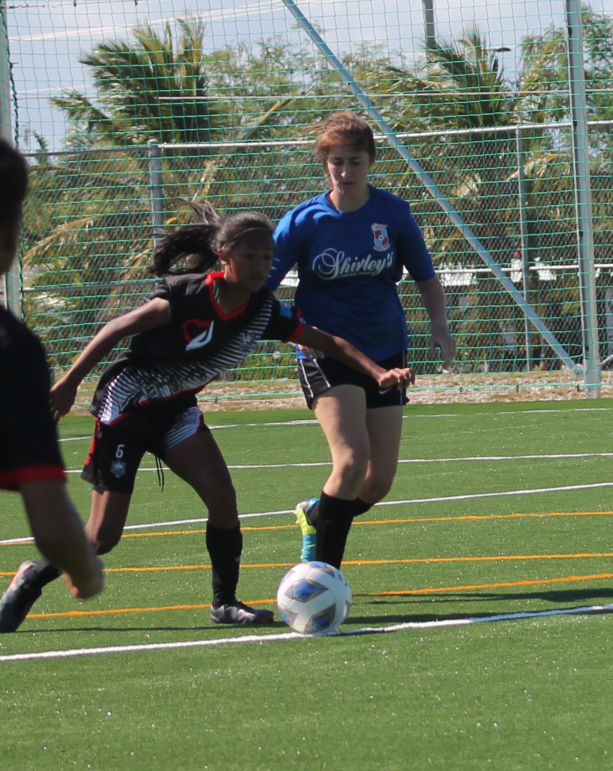 Southern United Football Club’s Kaithlyn Chavez pushes forward as Shirley's Football Club’s Gabi Race closes in during a game of the Dove Women's League Spring 2021, Division A at the NMI Soccer Training Center’s mini-pitch.Photo by James F. Sablan Jr.
