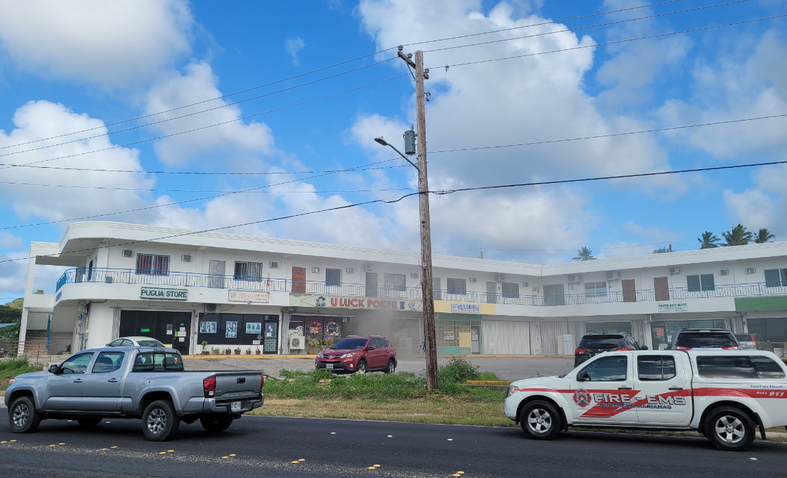 Smoke is seen coming from the door of U Luck Poker II in Gualo Rai on Monday afternoon.Photo by Bryan Manabat