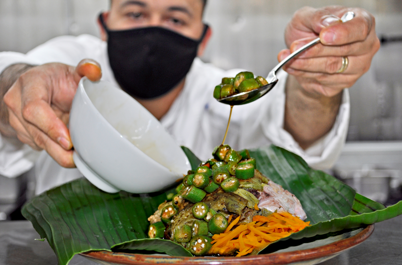 Zenn Tomokane shows a meal that consists of newly harvested eggplants charred over fire and placed on fresh Marianas fish wrapped in young banana leaf and baked. It is served with finadeni seasoned okra and pickled green papaya. Contributed photo