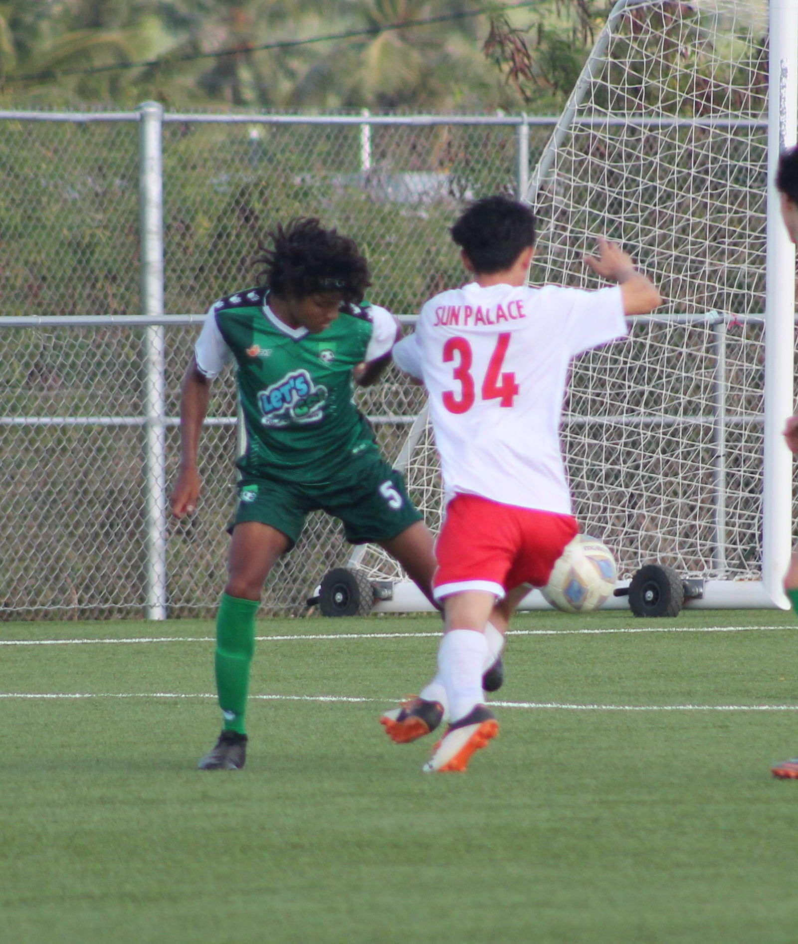 TanHoldings’ Yanai Ryuto battles for the possession against The One's Ri Cheng Xian during a game of the Men's M-League Spring 2021 Division A on Sunday at the NMI Soccer Training Center.Photo by James F. Sablan Jr.