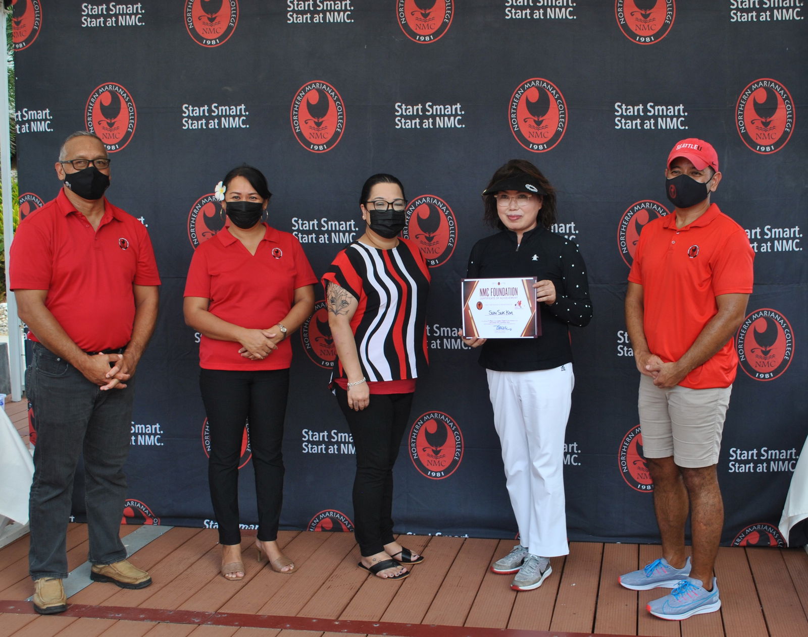 Sun Suk Kim, 2nd right, finished first in the ladies open division of the 16th Annual NMC Golf Tournament at the LaoLao Bay Golf & Resort on Saturday. With her in the photo are Northern Marianas College officials.Photo by James F. Sablan Jr.