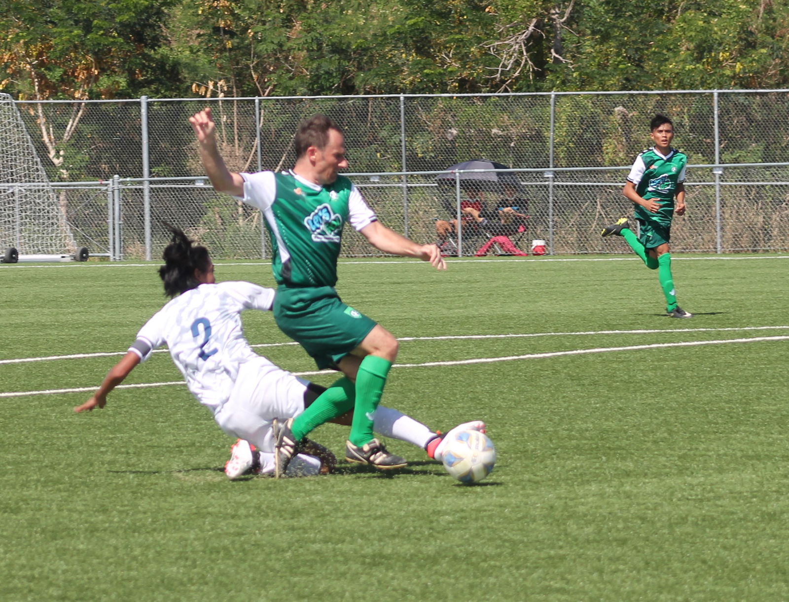 TanHoldings’ Martin Jambor tries to maintain possession as a defender slides in for the steal during a Men's M-League Spring 2021 Division A game, Sunday, at the NMI Soccer Training Center in Koblerville.Photo by James F. Sablan Jr.