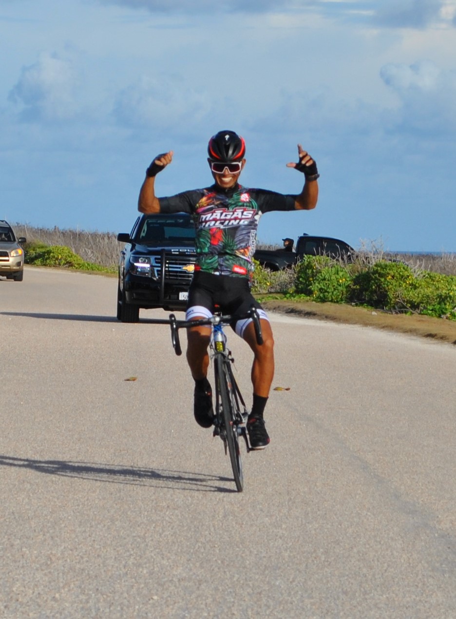 Joel Buco celebrates as he crosses the finish line of the Saipan Unity Lions Club's 5th Annual Bike Race on Sunday at Banzai Cliff.Photo by James F. Sablan Jr.