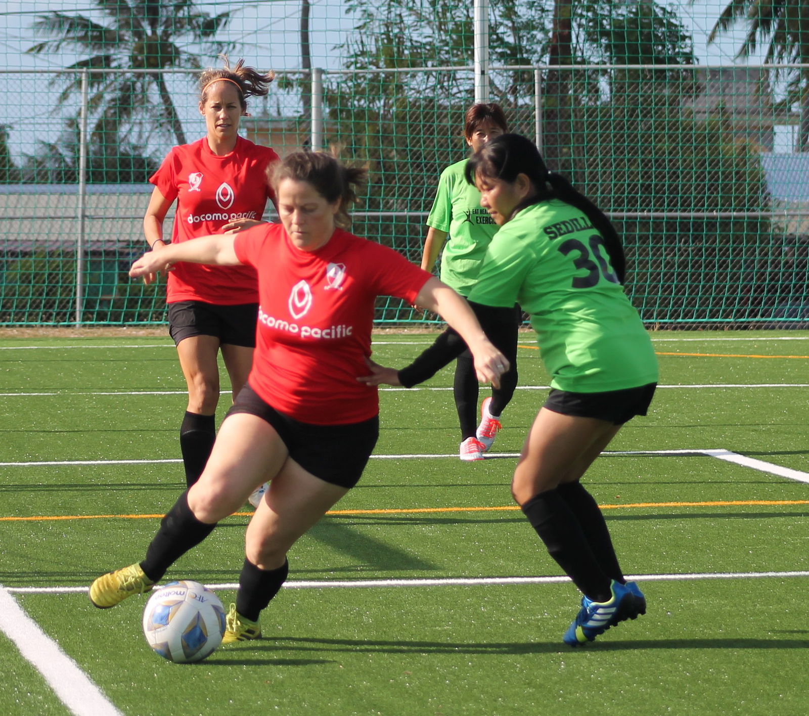 Paire 1's Lindsay Davis dribbles near the edge of the playing field as she battles for possession during a Dove Women's League Spring 2021 Masters Division game at the NMI Soccer Training Center.Photo by James F. Sablan Jr.
