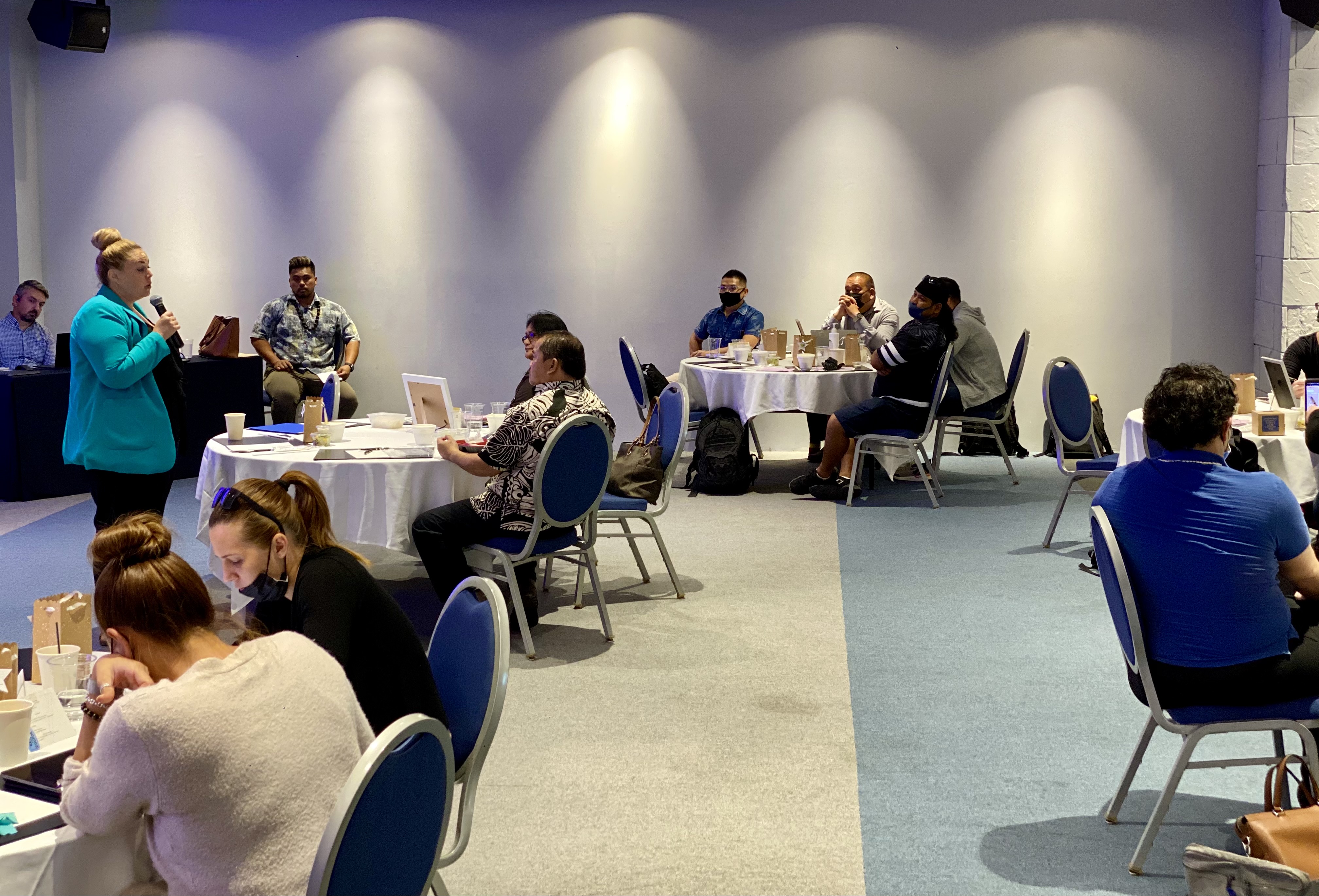 Office of Public Auditor legal counsel Ashley Kost, left standing, talks about the Code of Ethics. Also in photo: Public School System legal counsel Tiberius Mocanu, left background, seated