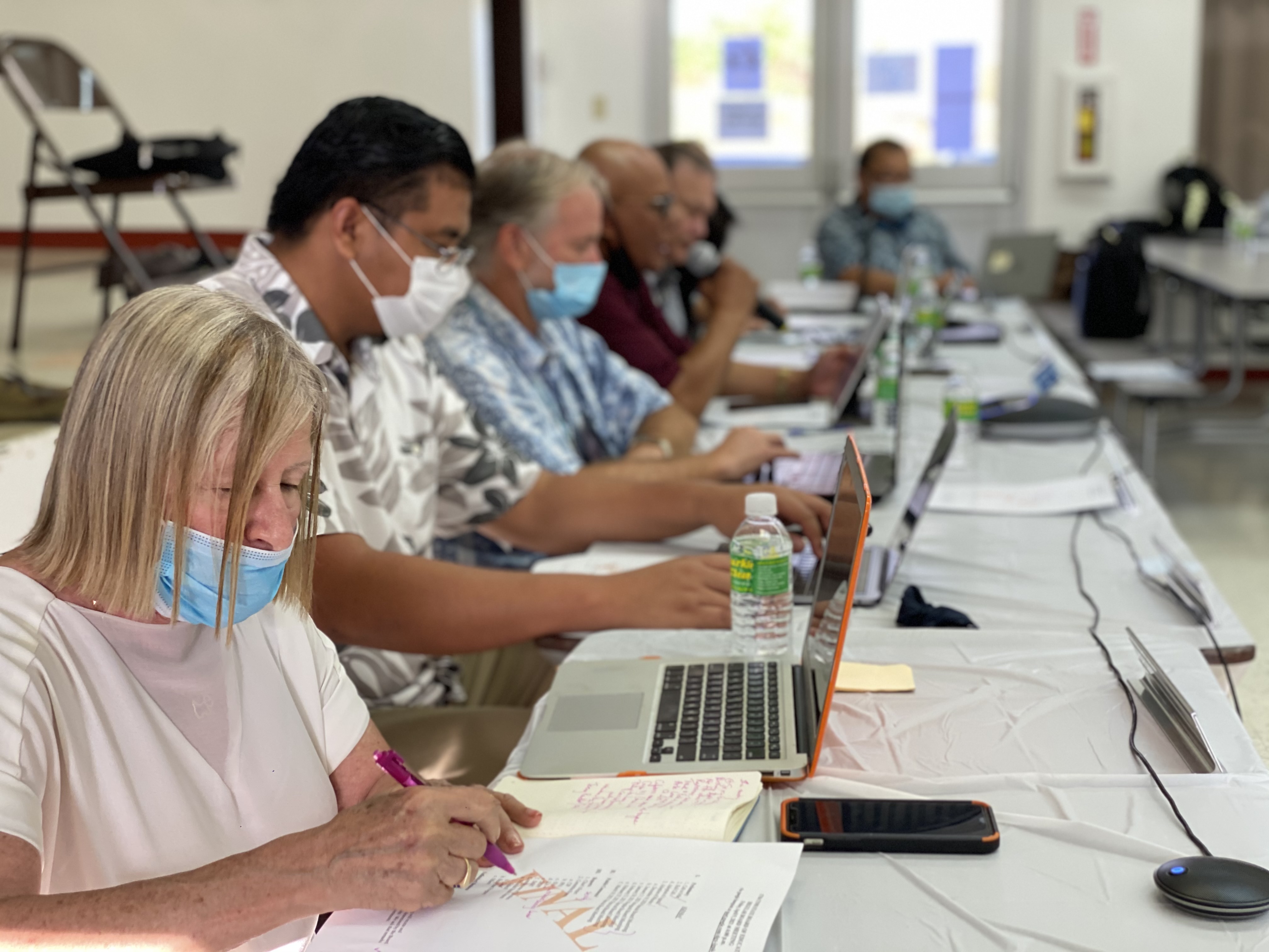Teacher representative Phyllis Ain, left, joins a Board of Education meeting.