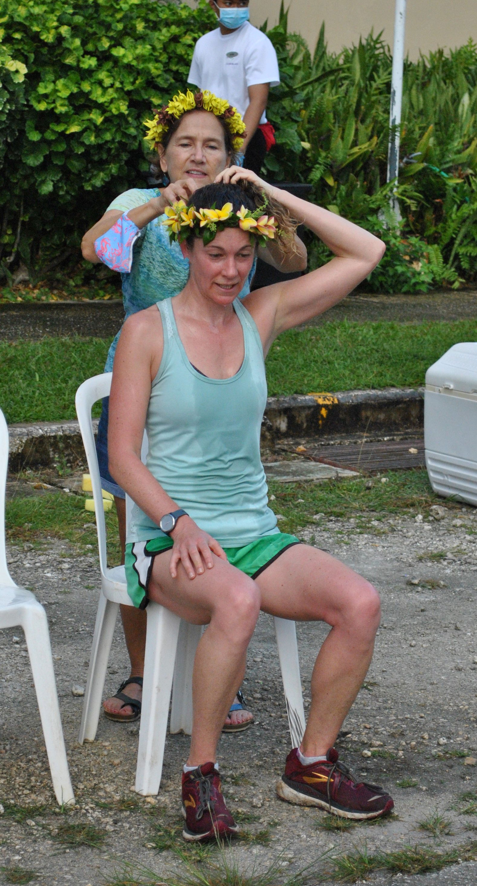 Lily Muldoon, seated,  receives a mwar from Marcia Schultz after topping the race.
